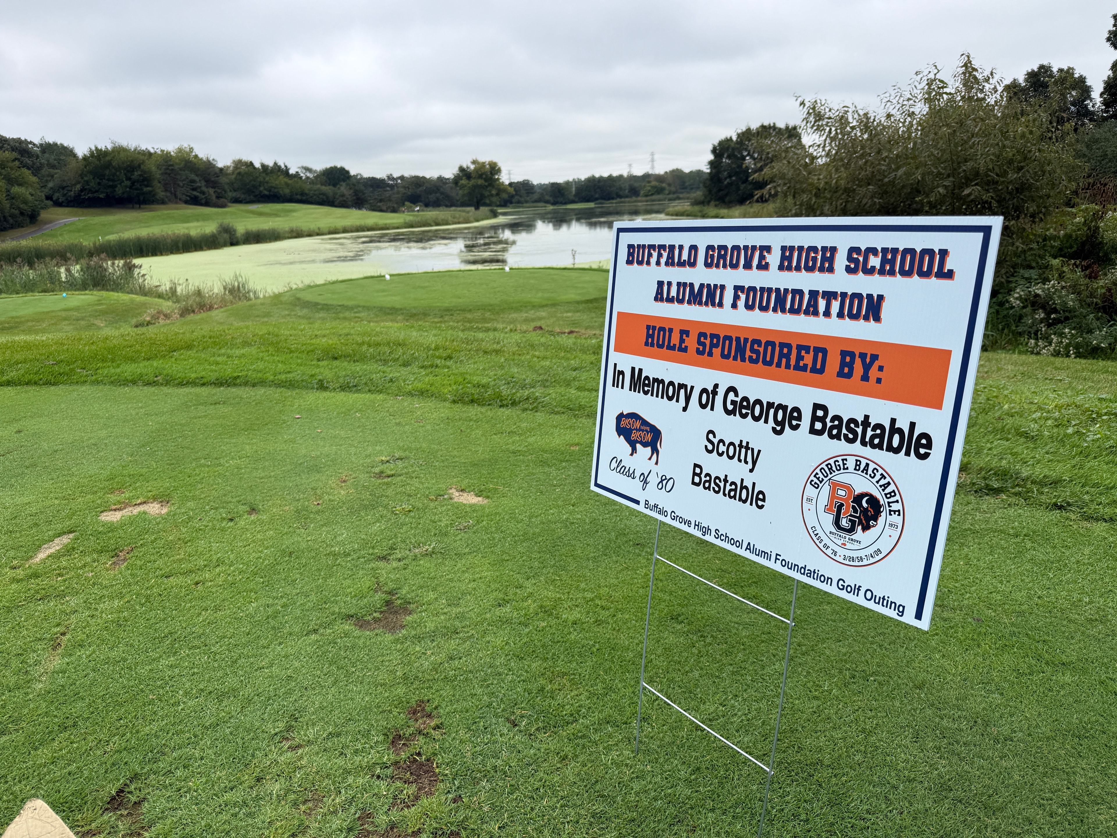 Golf course memorial sign by water