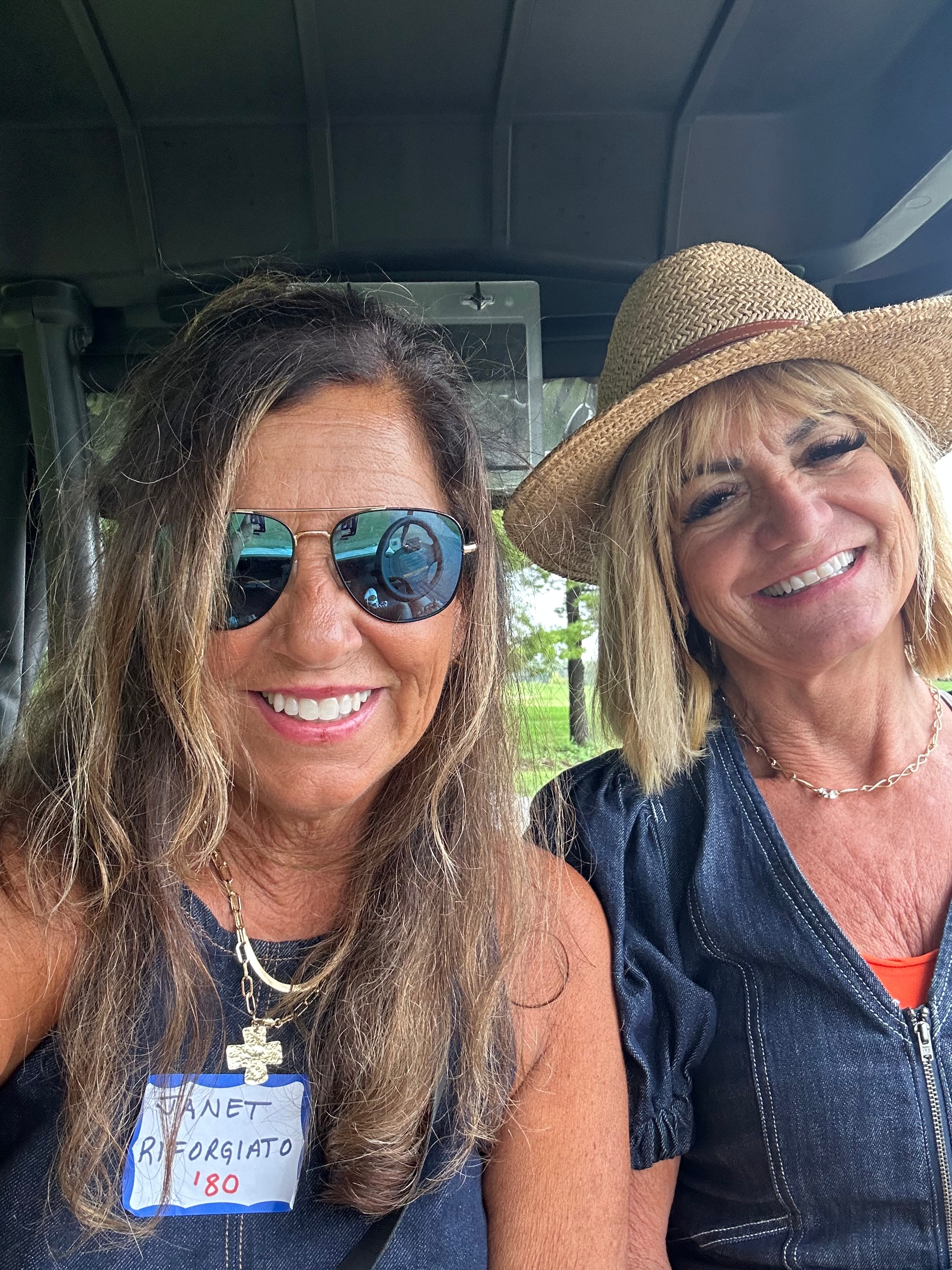 Two women smiling inside vehicle