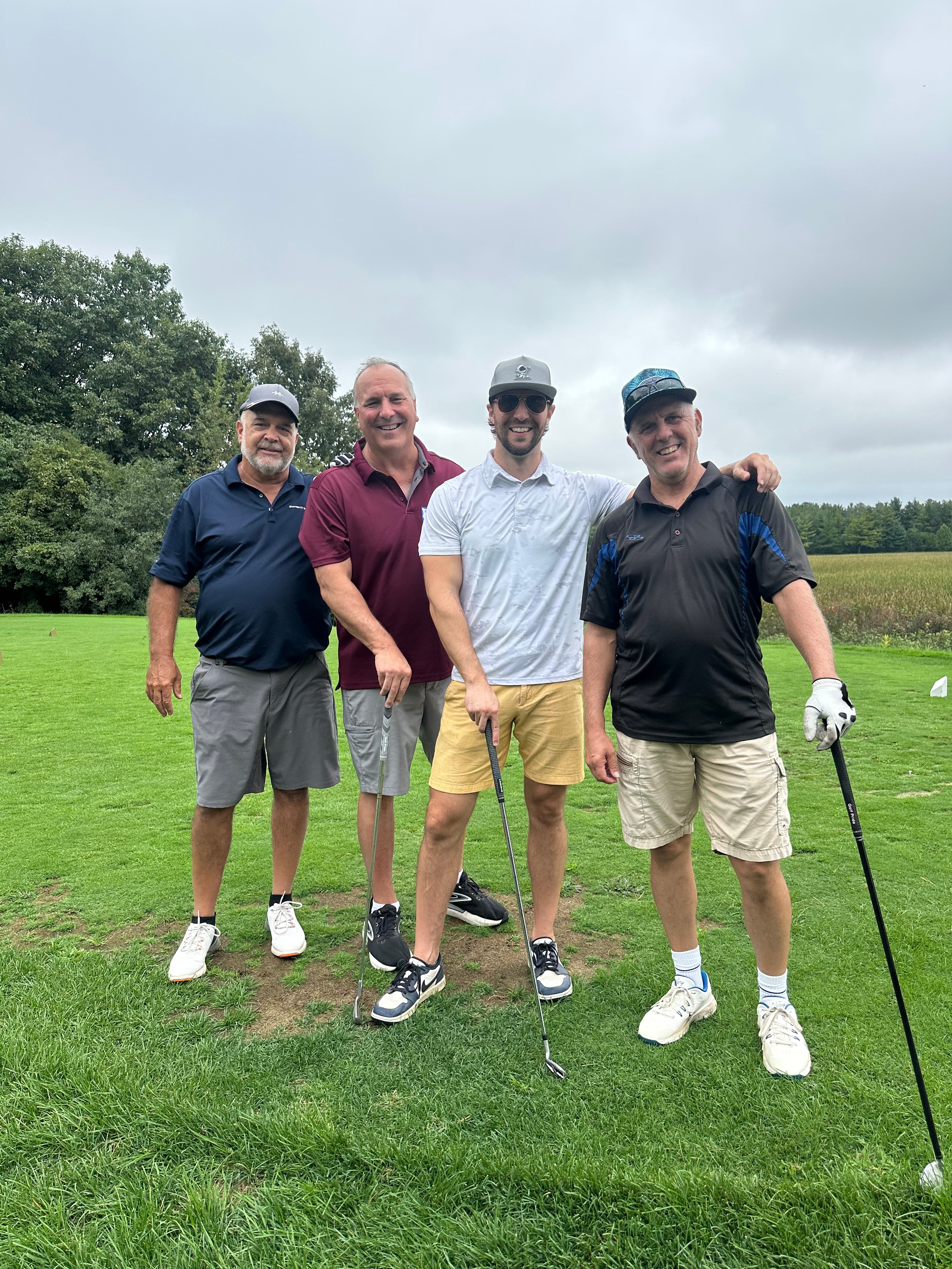 Four men golfing together on course