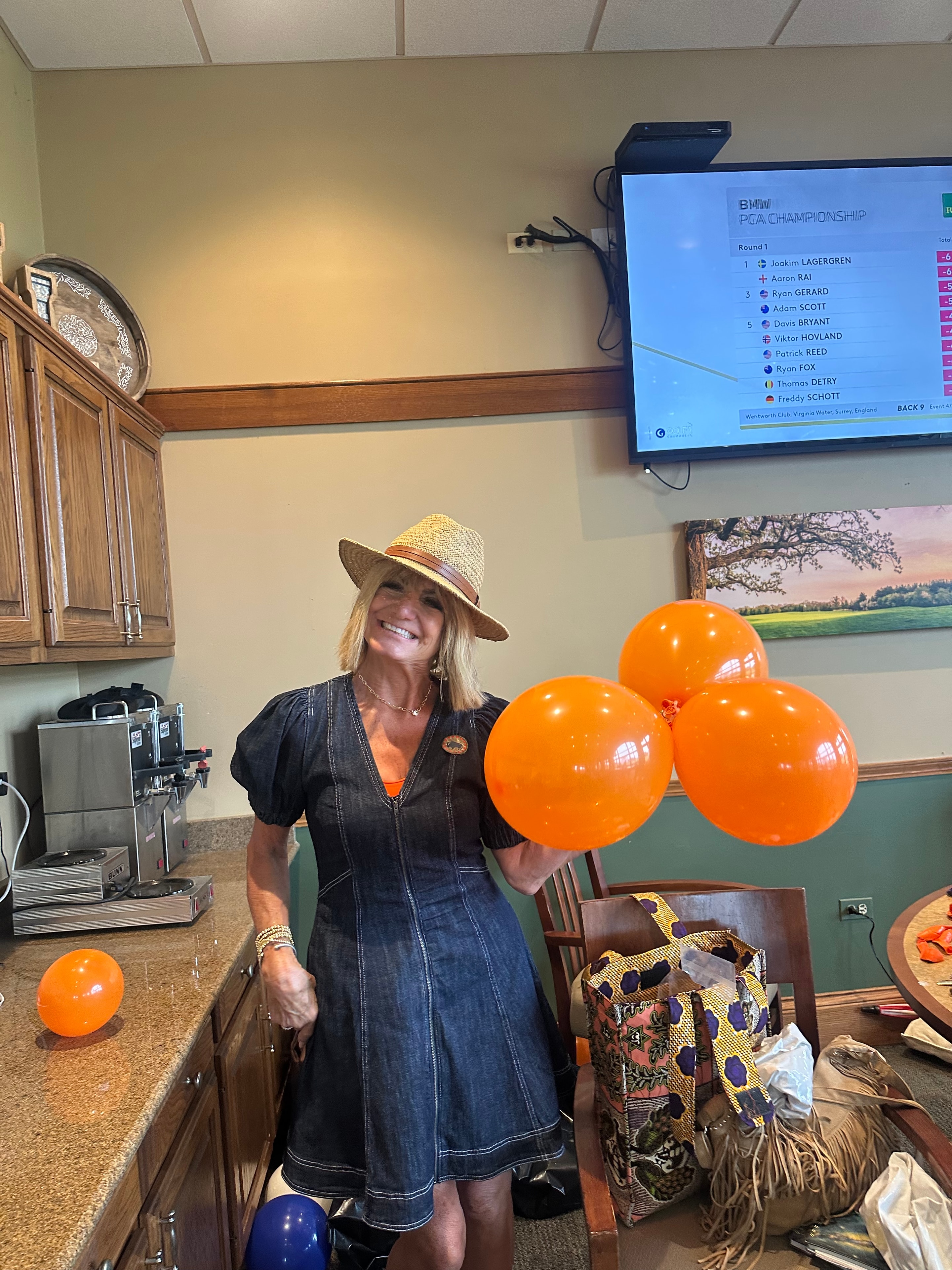 Woman holding orange balloons indoors