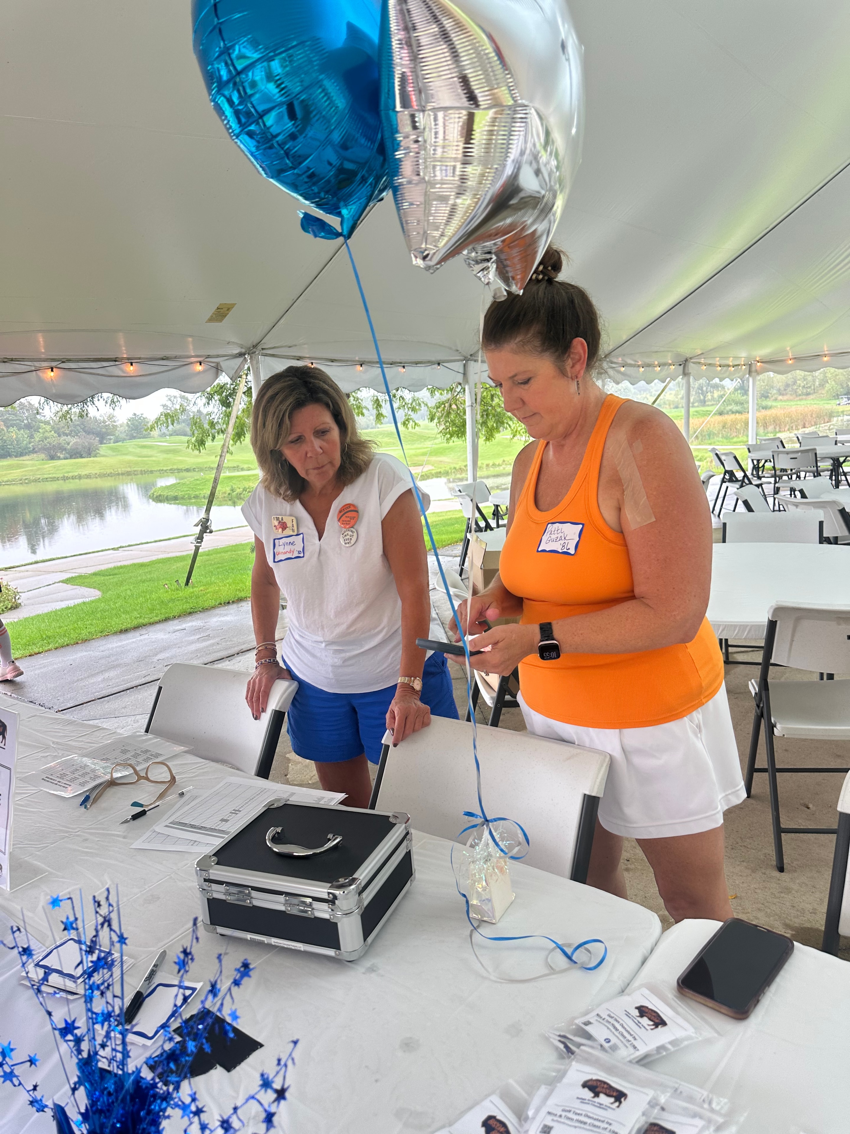 Women at outdoor event tent table
