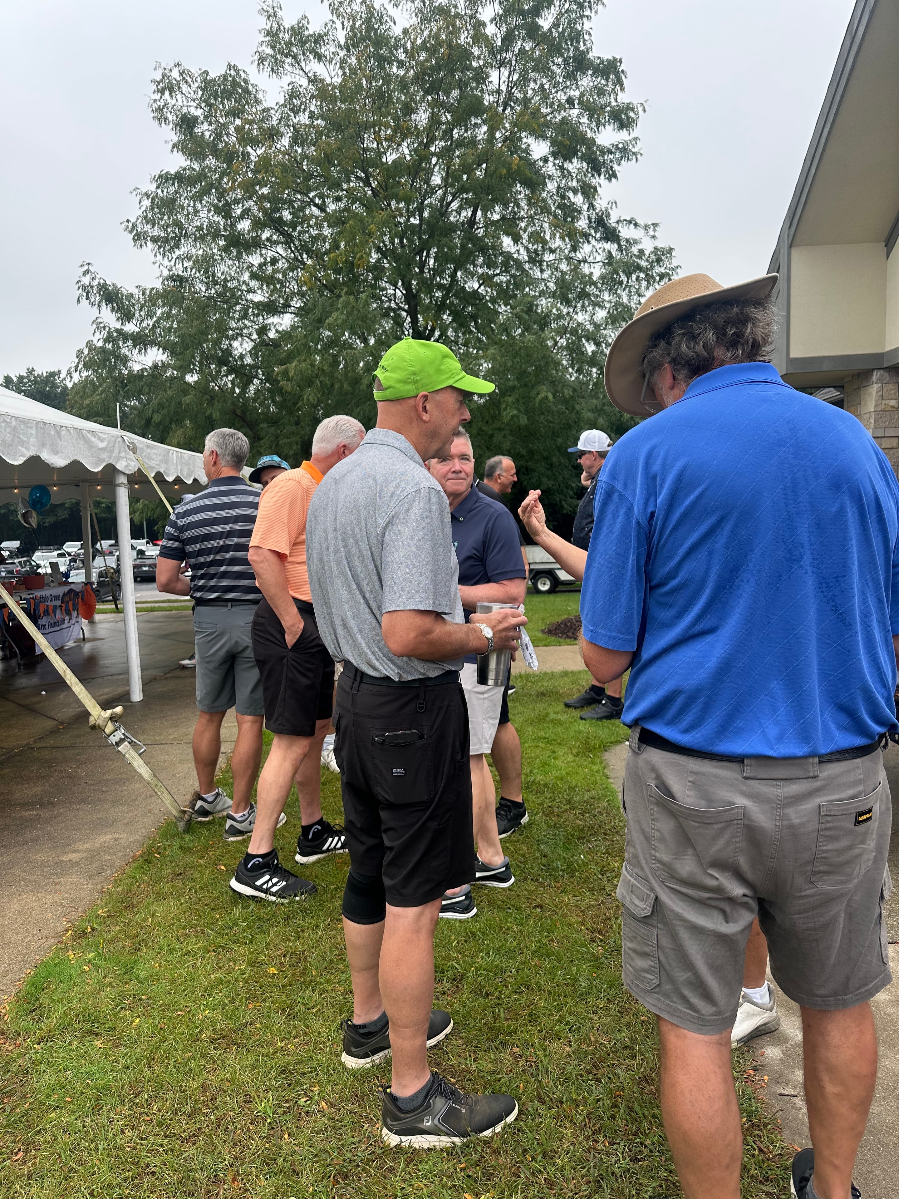 Group of men socializing at outdoor event