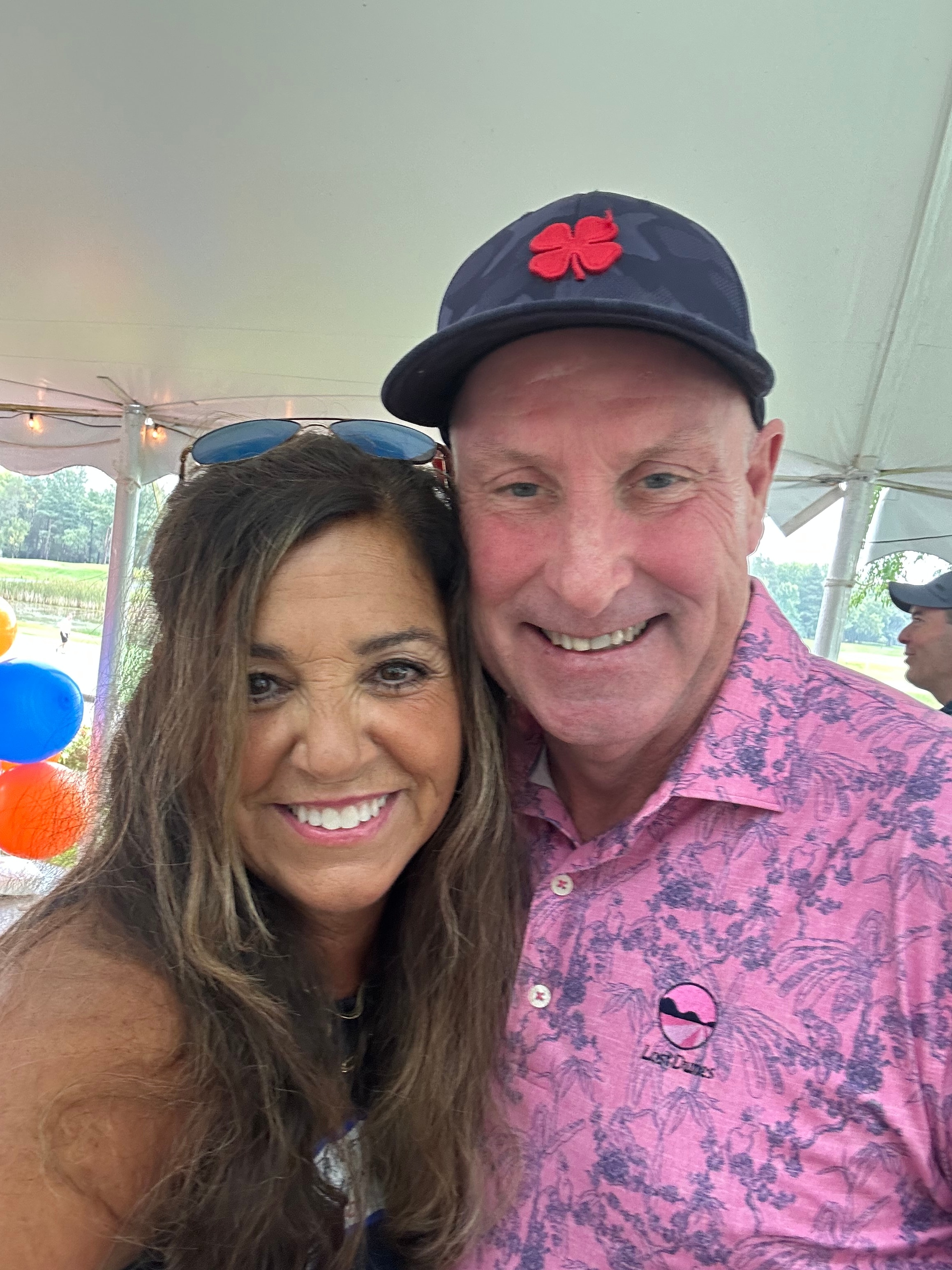 Couple smiling at outdoor event tent