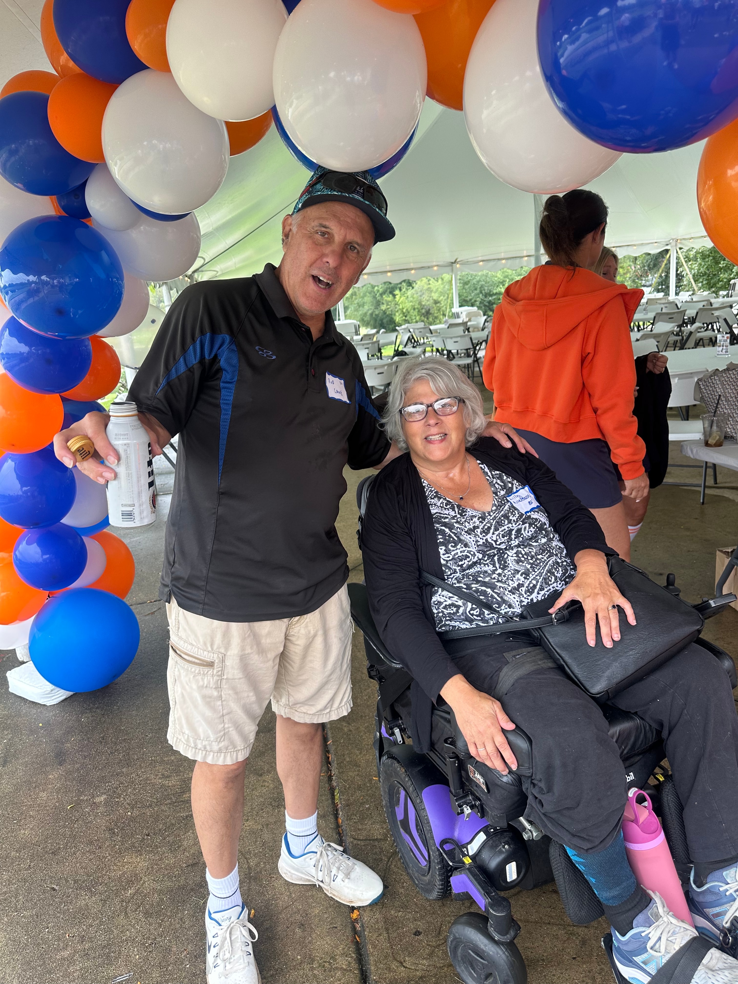 Man and woman at outdoor event with balloons