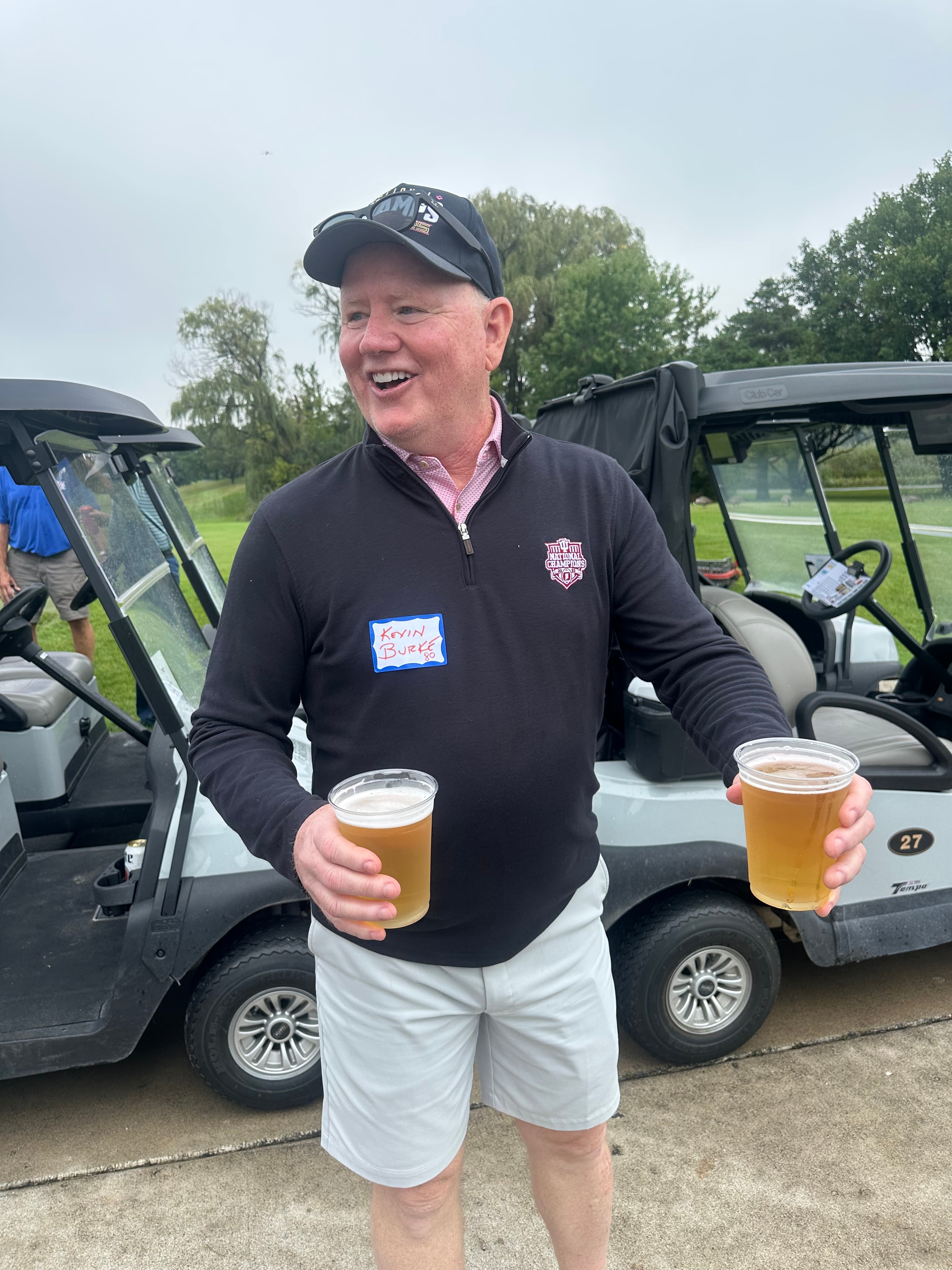 Man holding beers at golf course