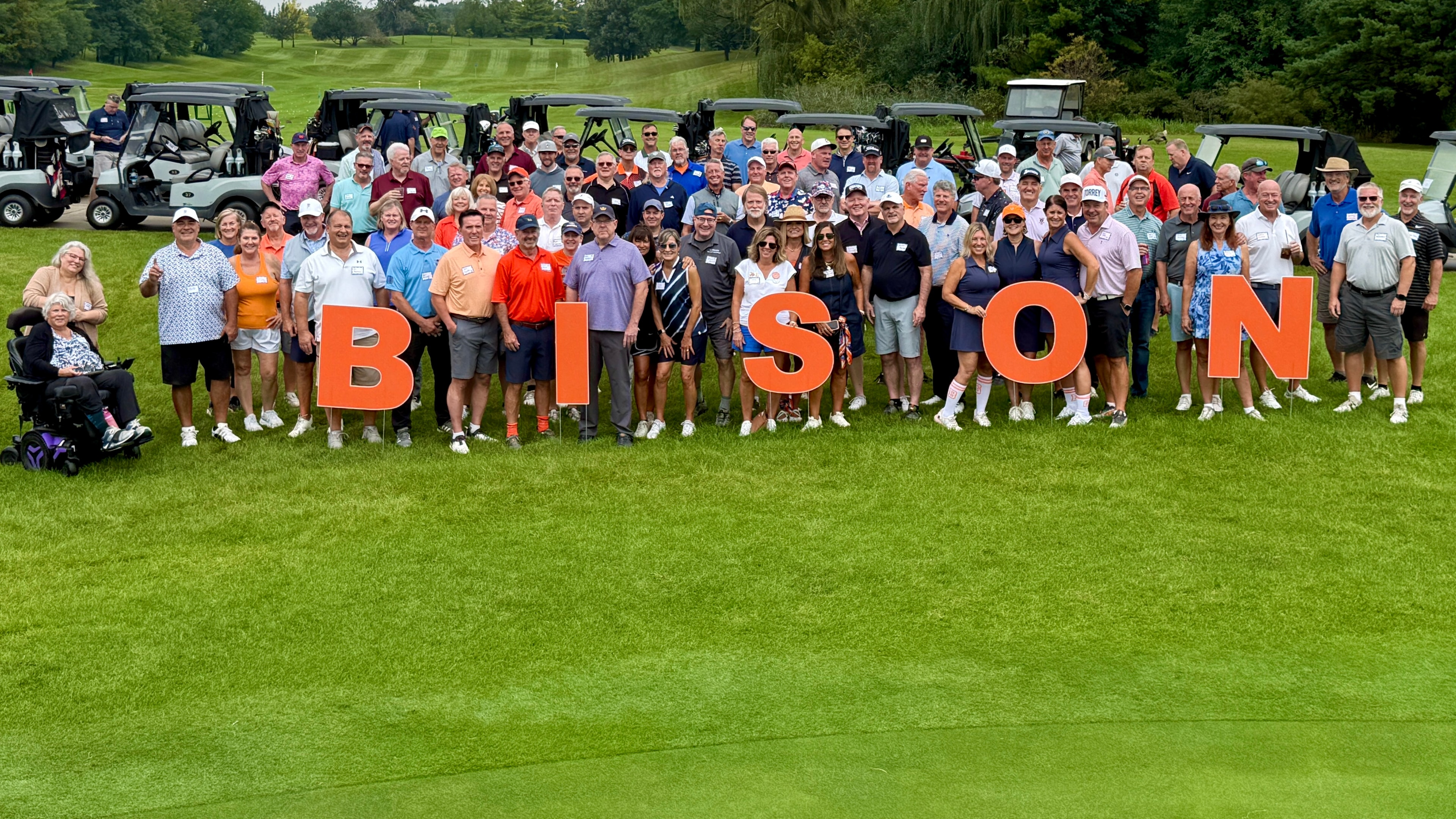 Large group posing at golf course event