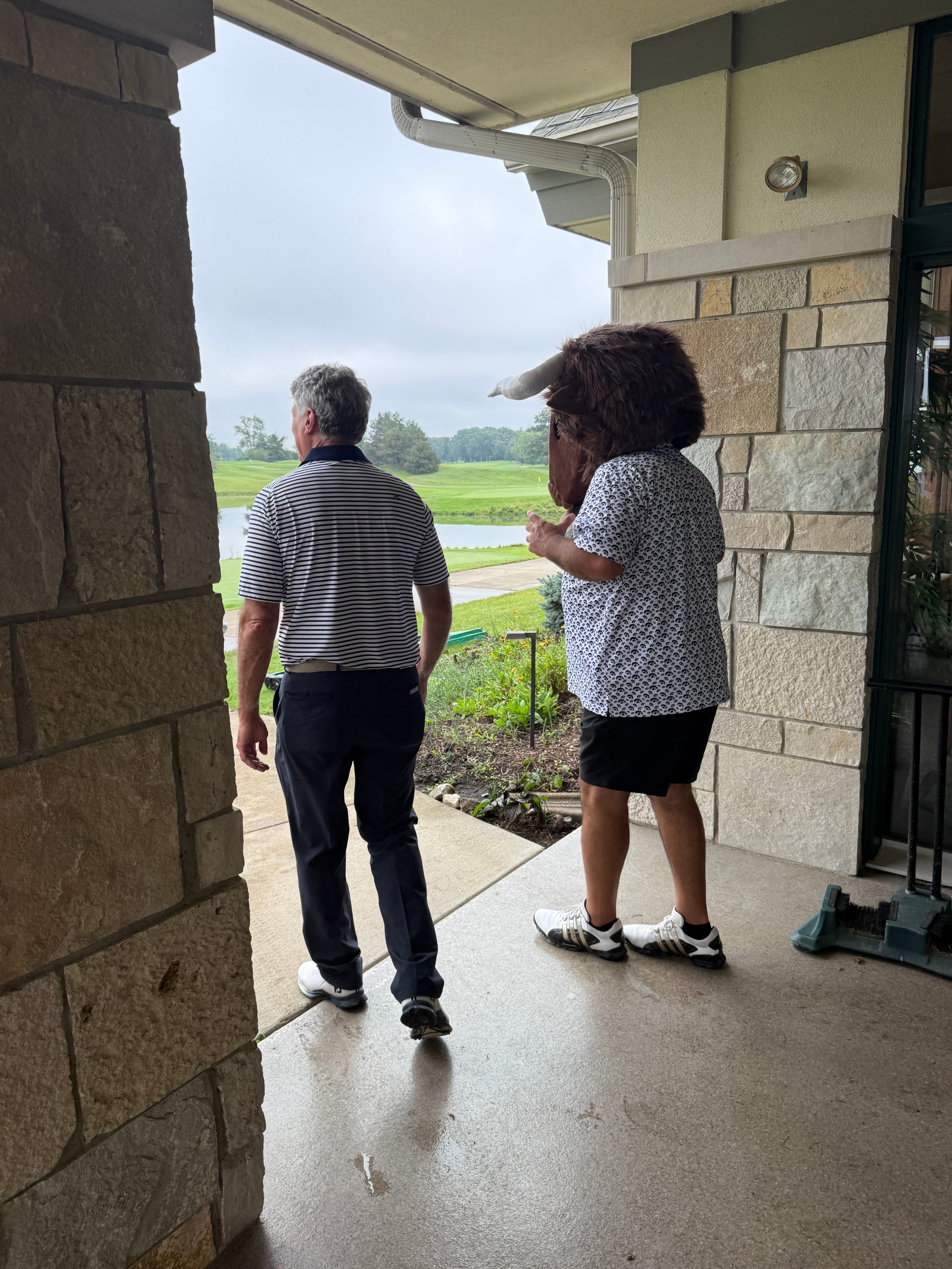 Two people viewing rural landscape from porch