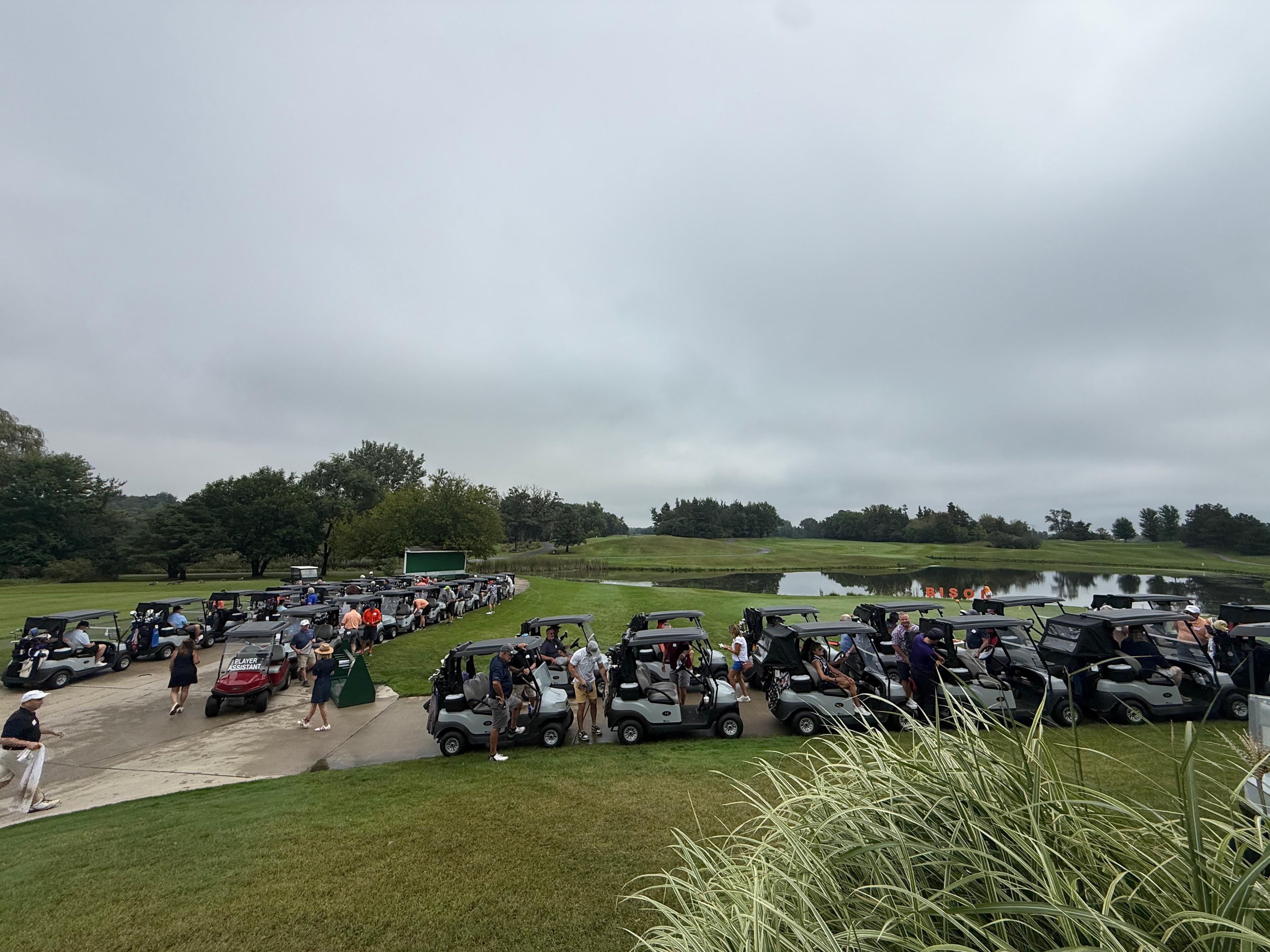 Golf tournament with multiple carts gathered
