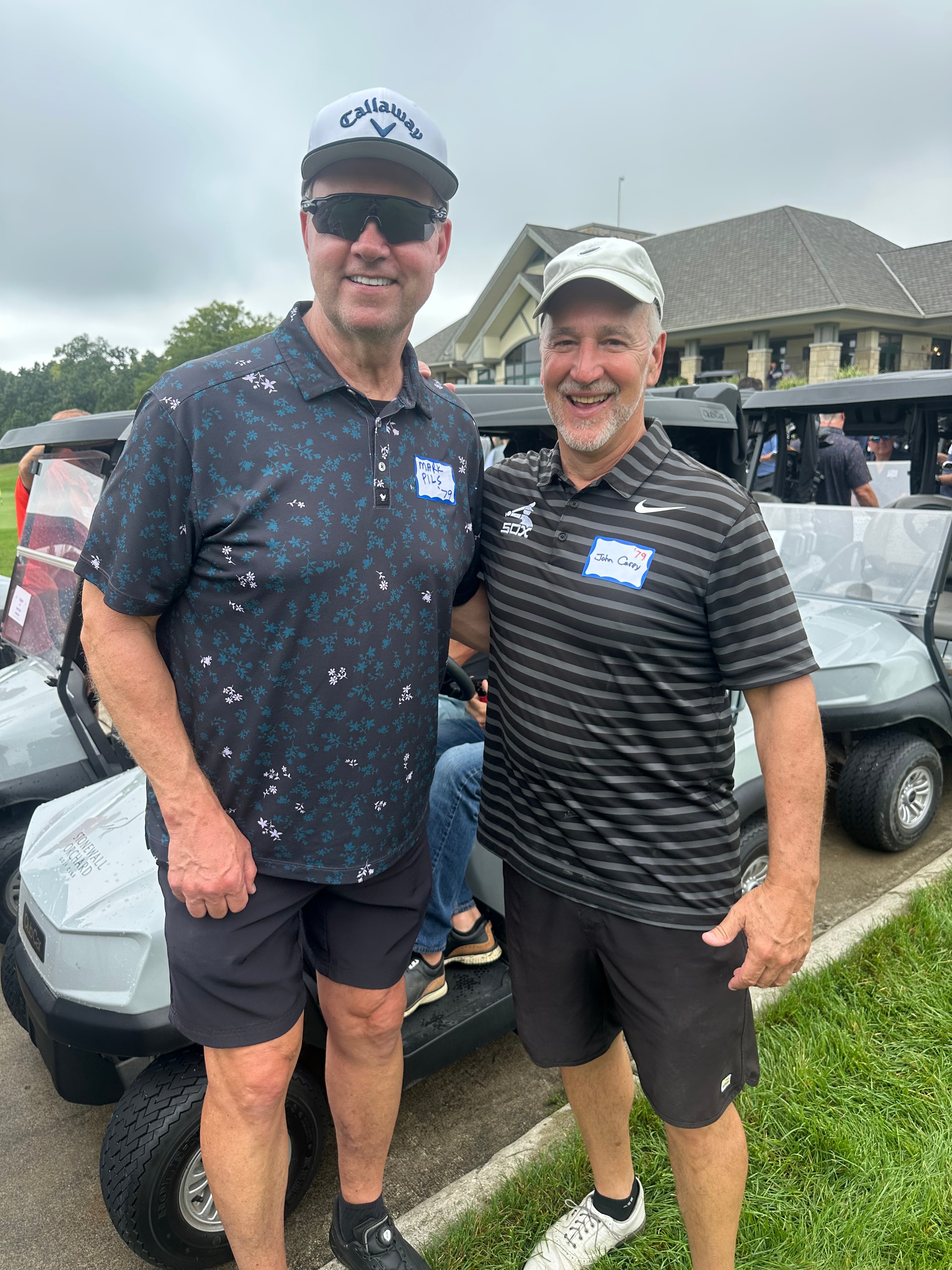 Two men posing at golf tournament