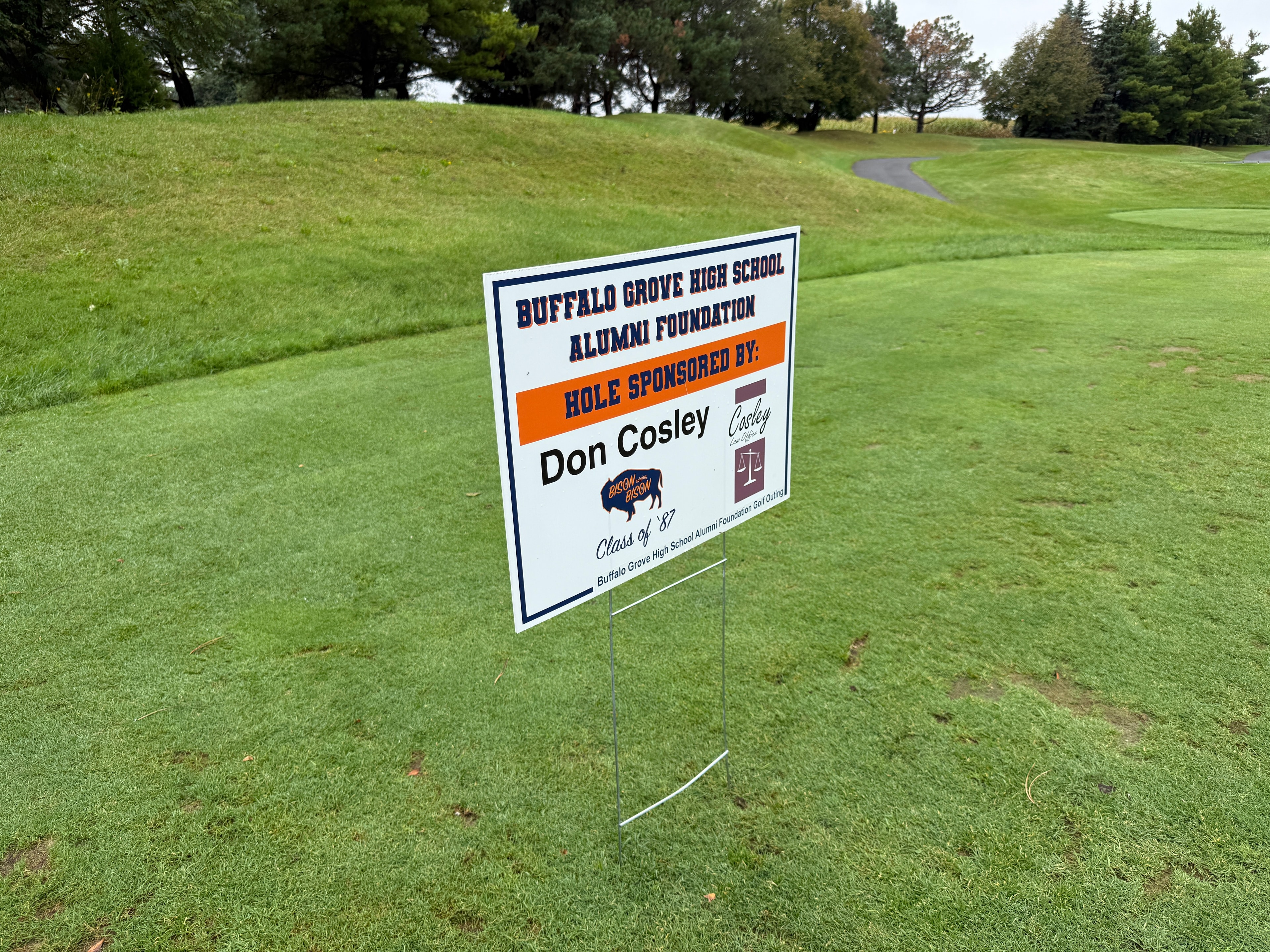 Golf course sponsorship sign on green field