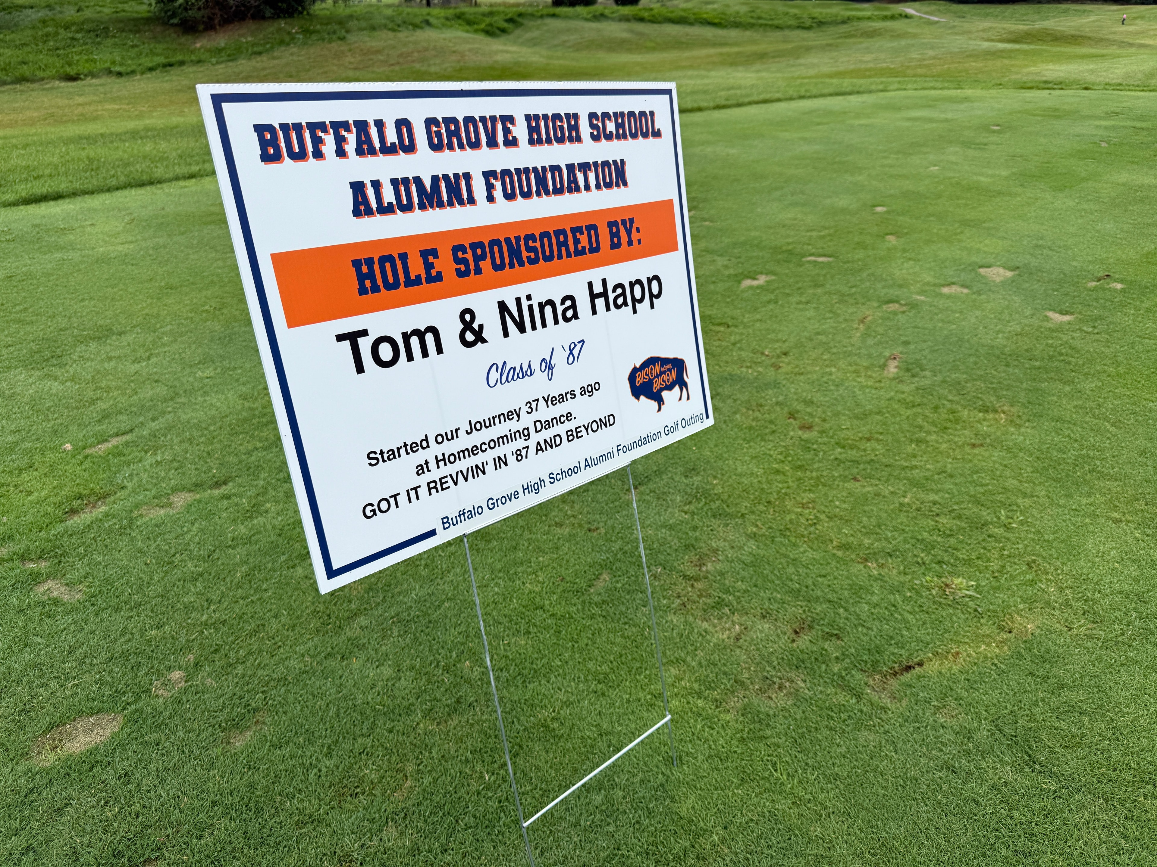 Golf course sponsorship sign on green lawn