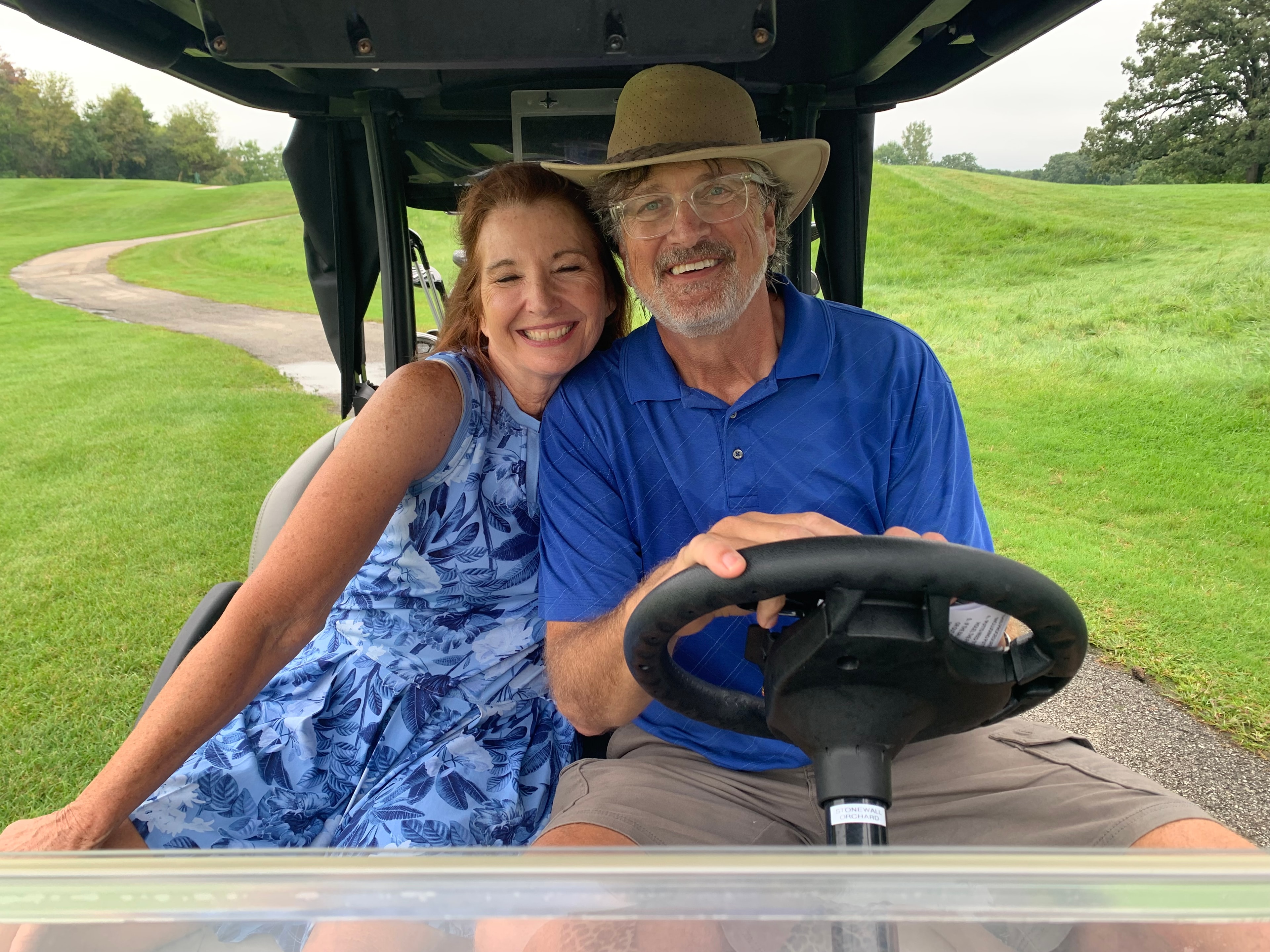 Couple in golf cart on course