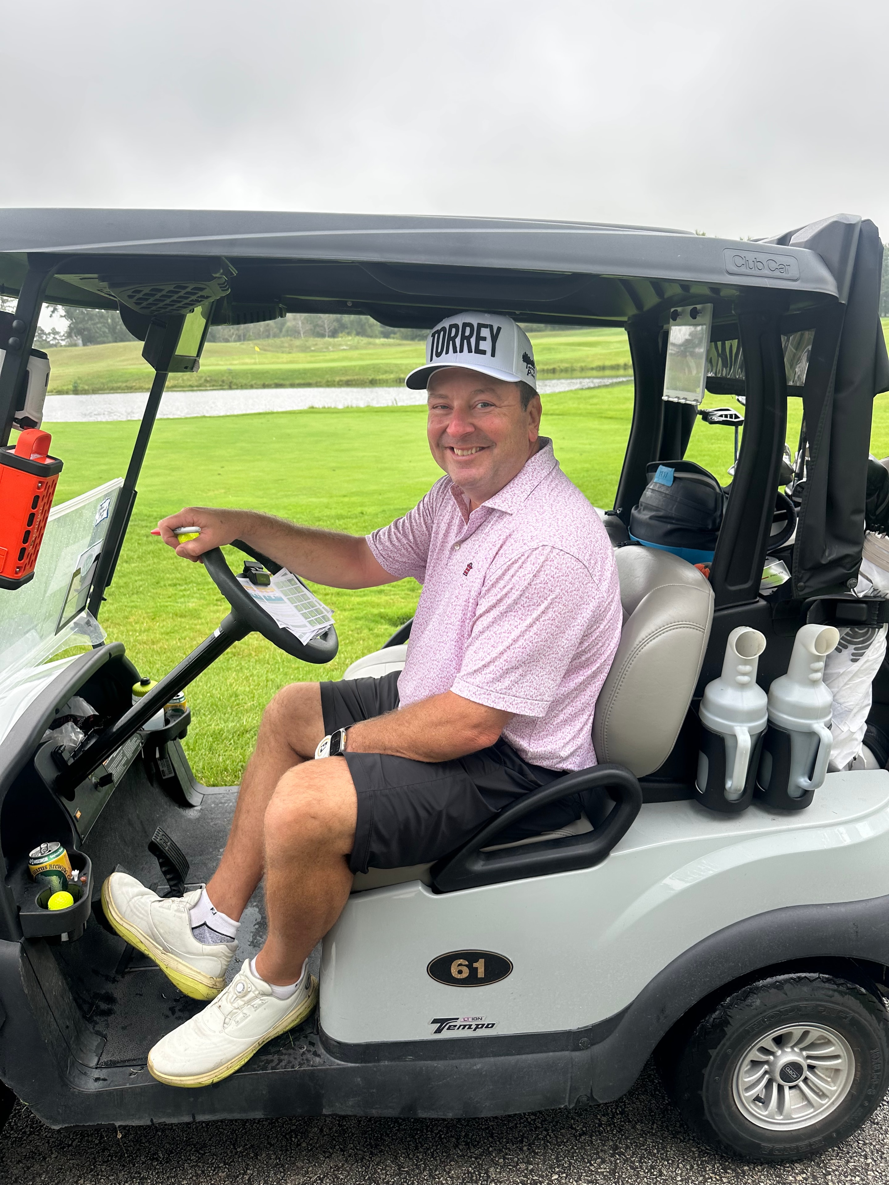 Man driving golf cart on course