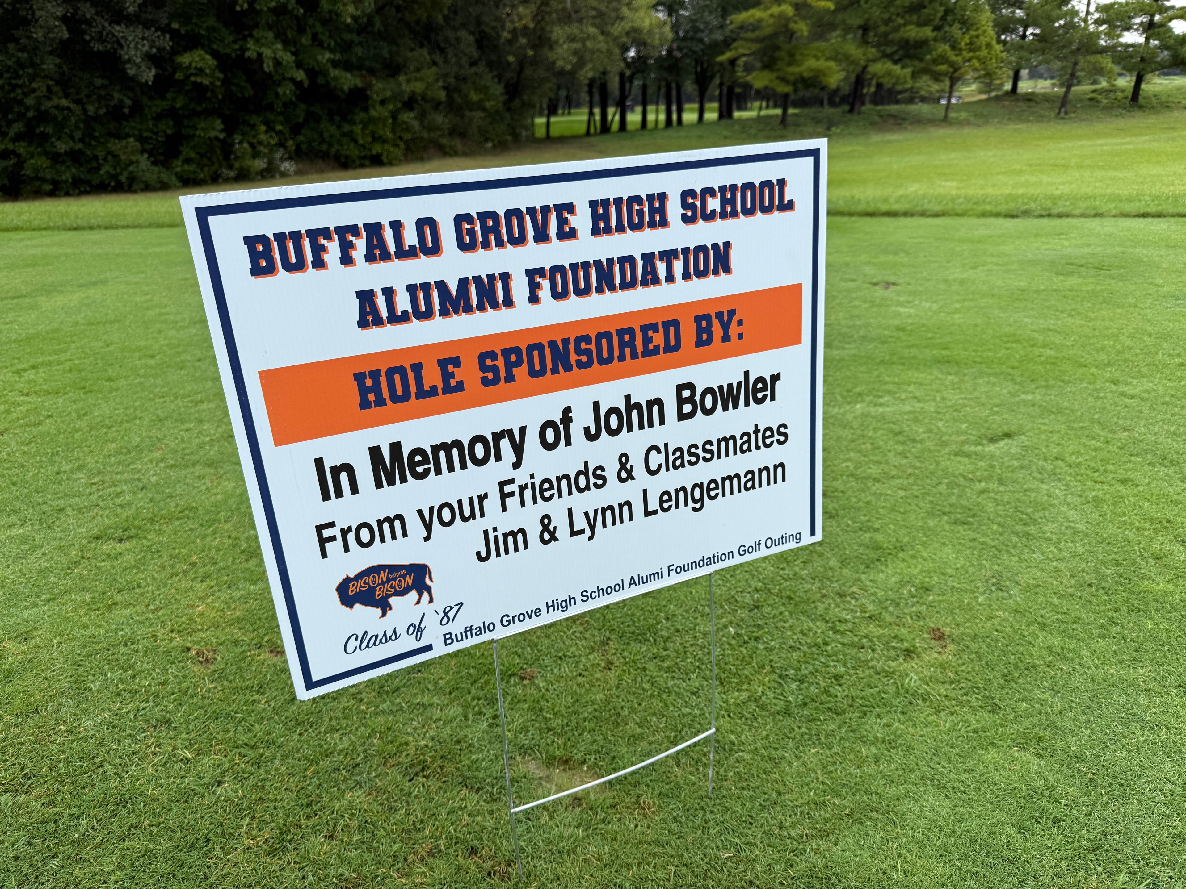 Golf course memorial sign on grass