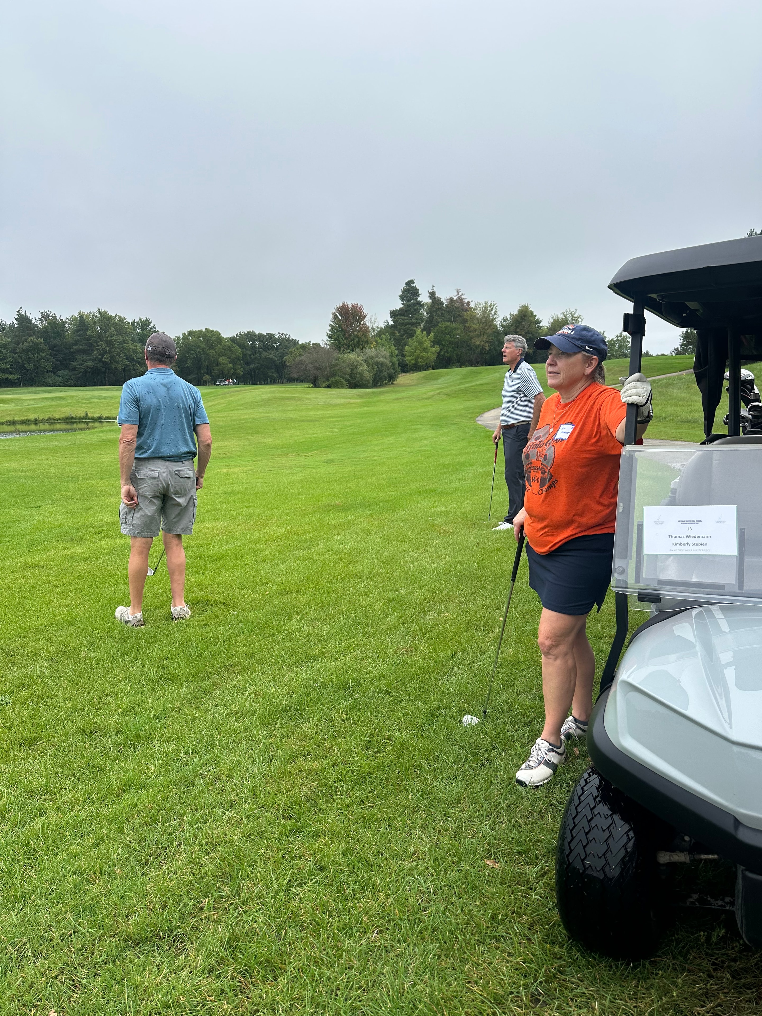 Golfers playing on green fairway