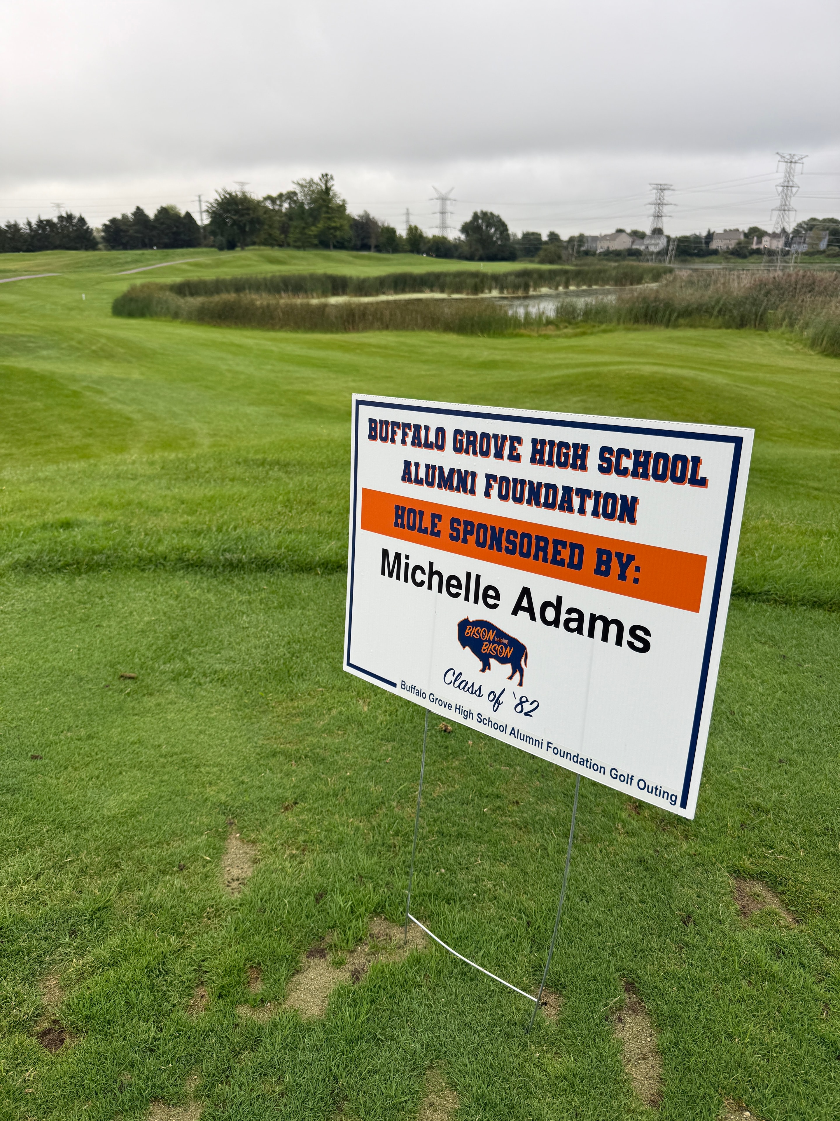 Golf course hole sponsor sign on green fairway