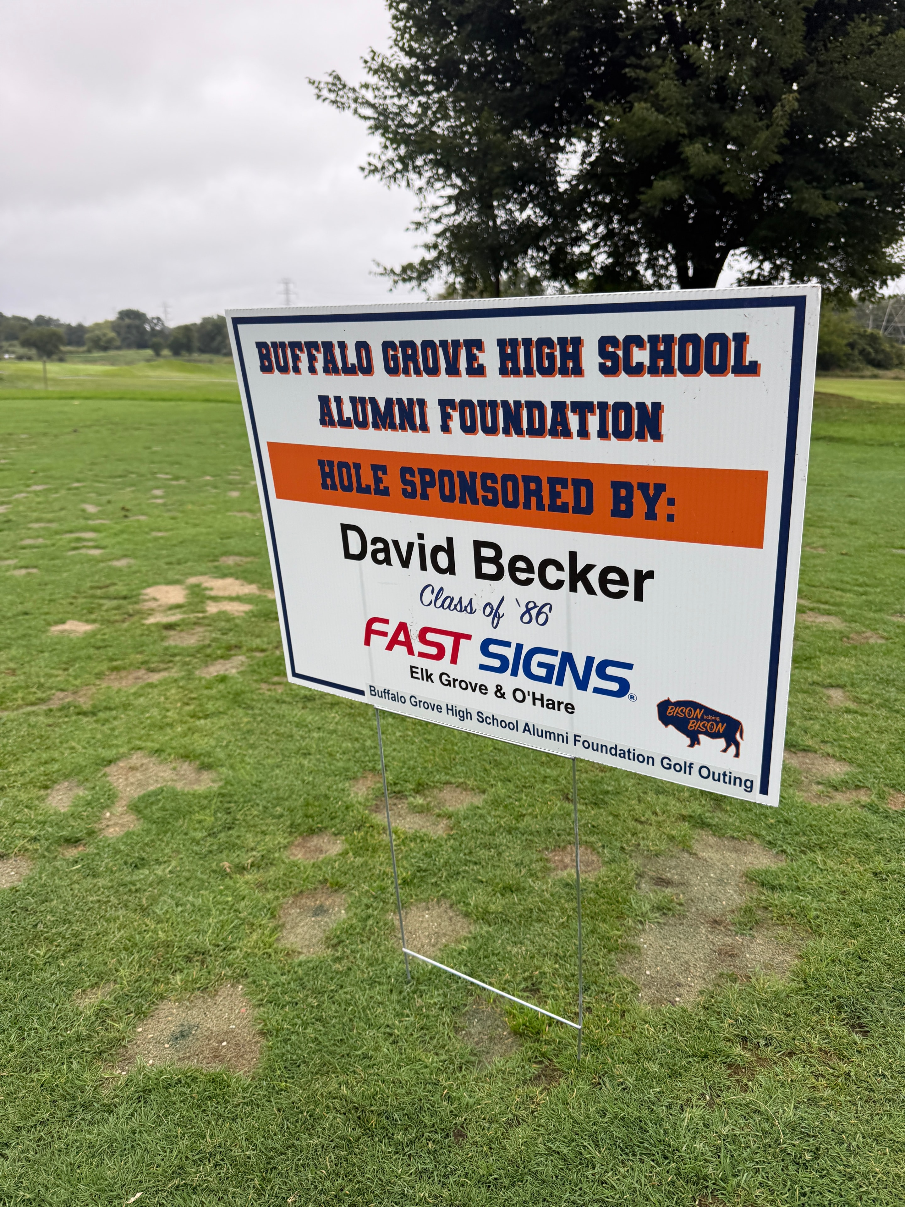 Golf course sponsorship sign on grass field