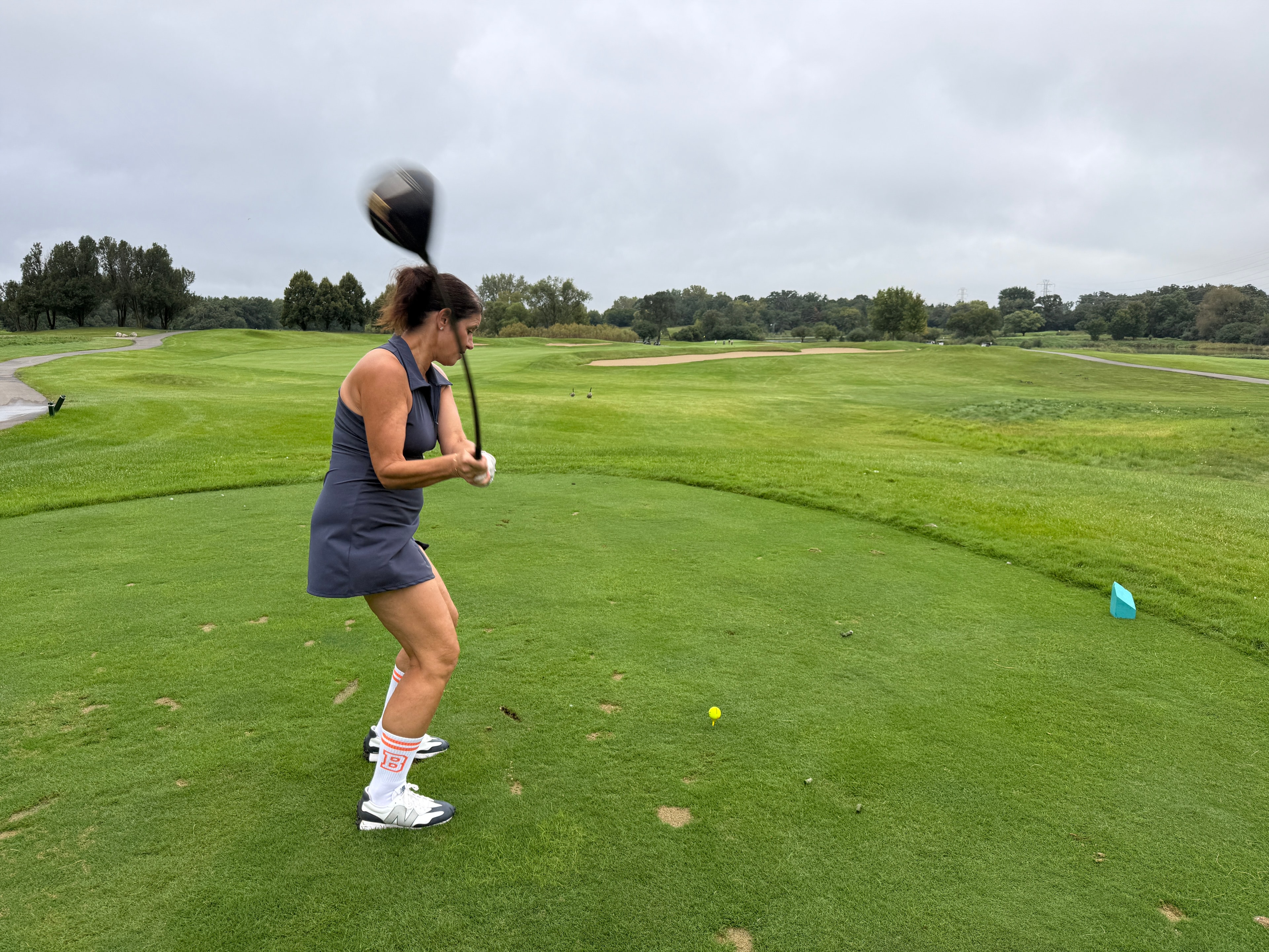 Woman playing golf on course