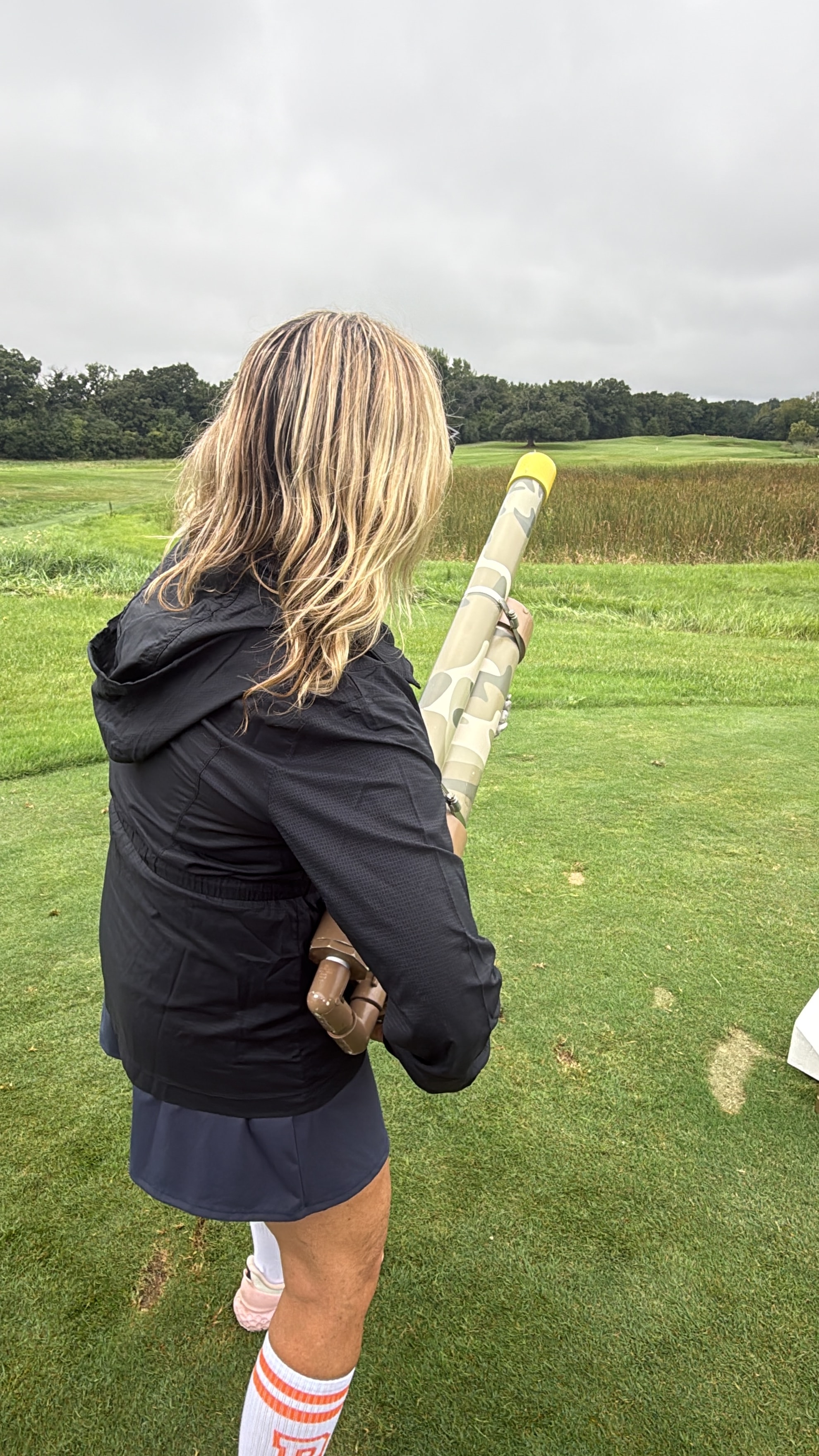 Woman holding golf ball cannon