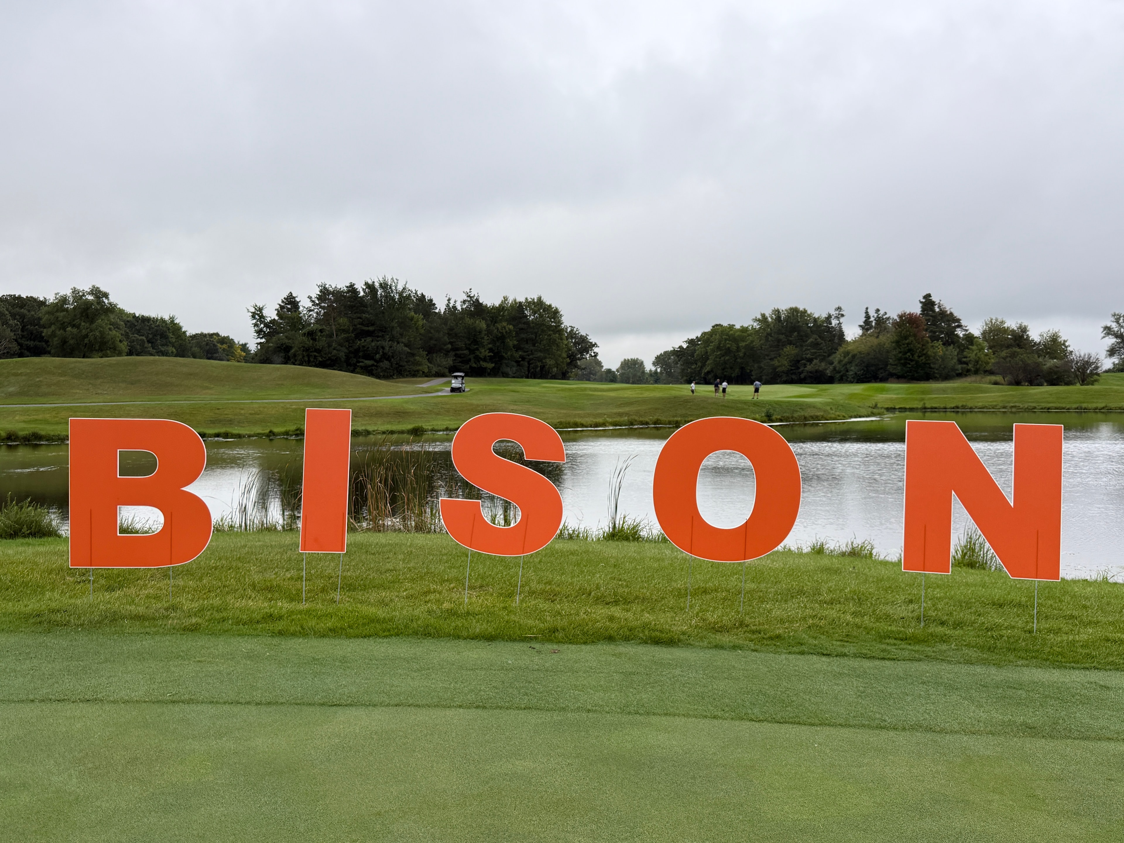 Large red Bison letters on golf course