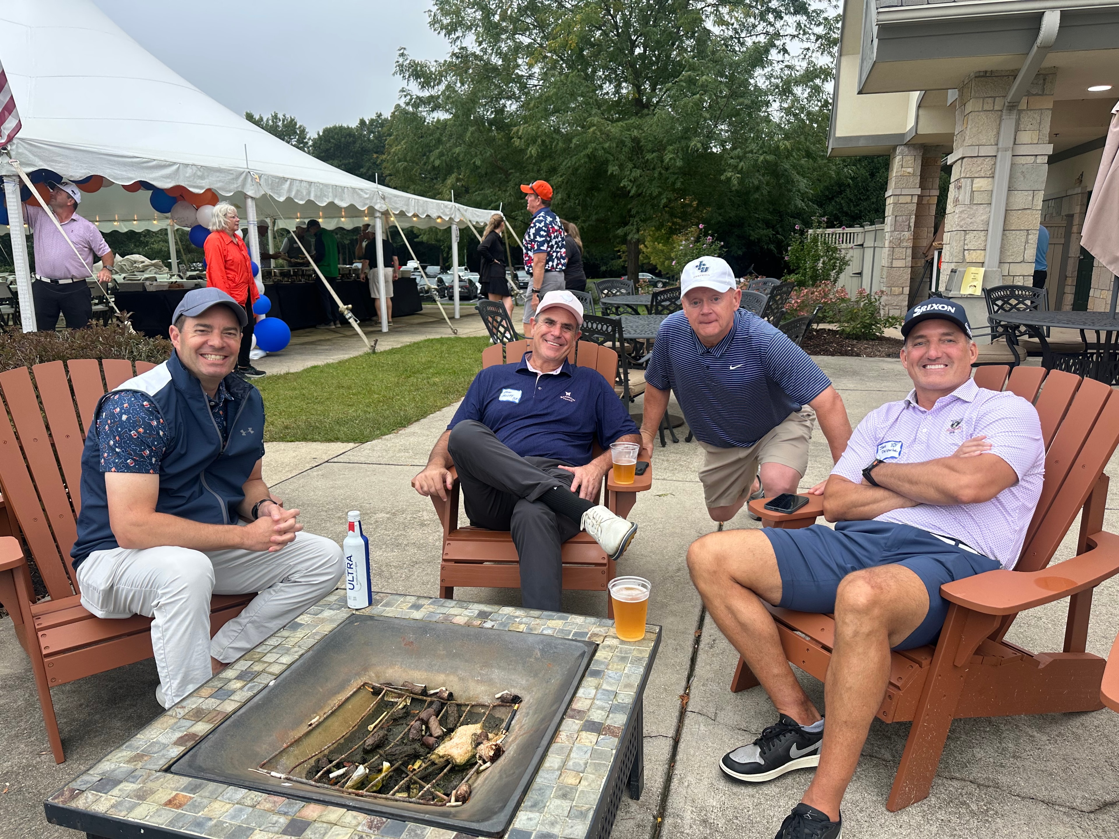 Men relaxing around outdoor fire pit