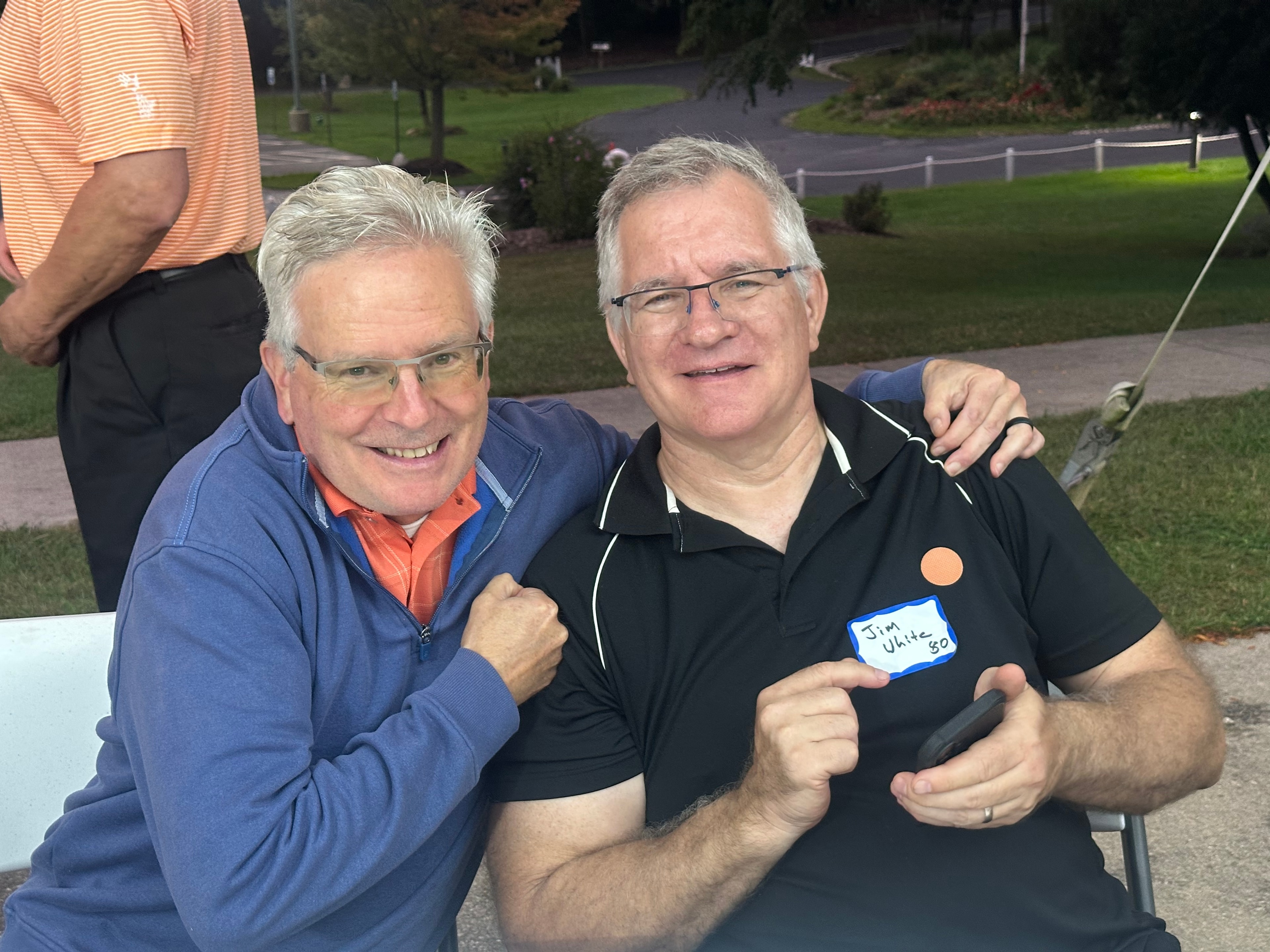Two men smiling at outdoor event