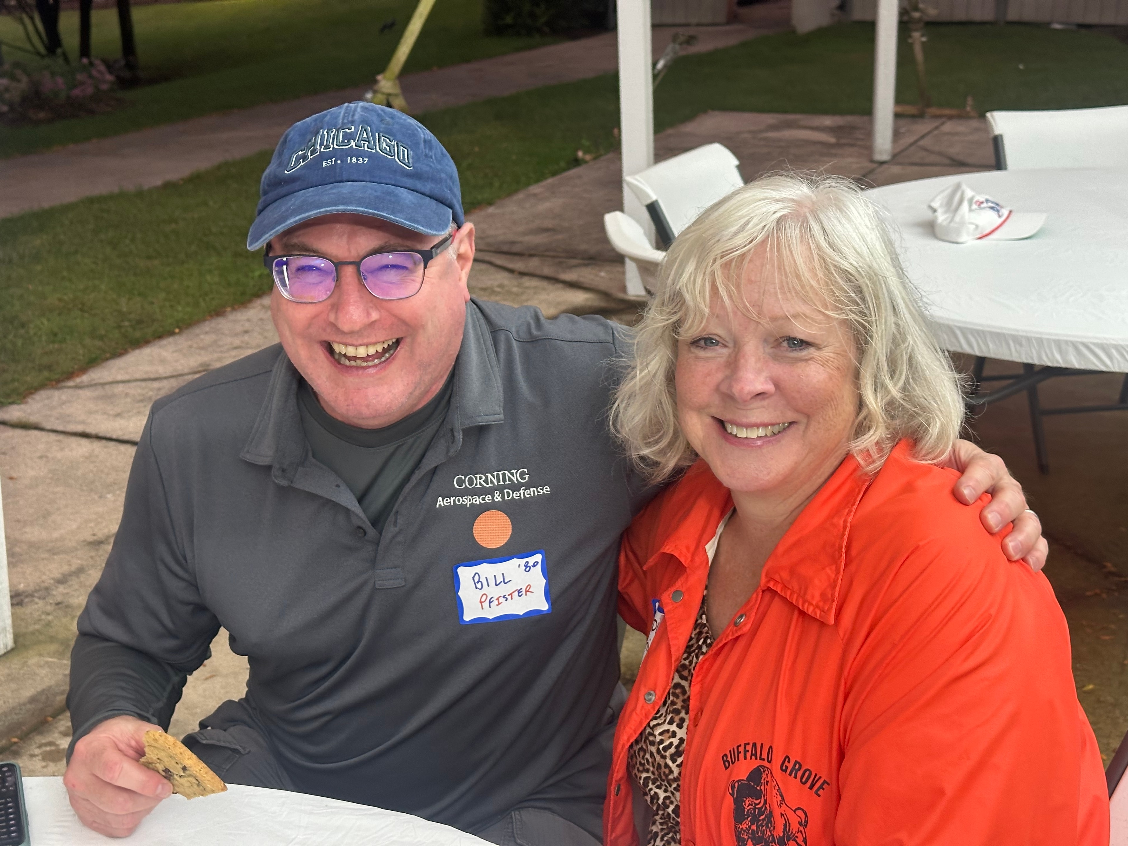 Two people smiling at outdoor event