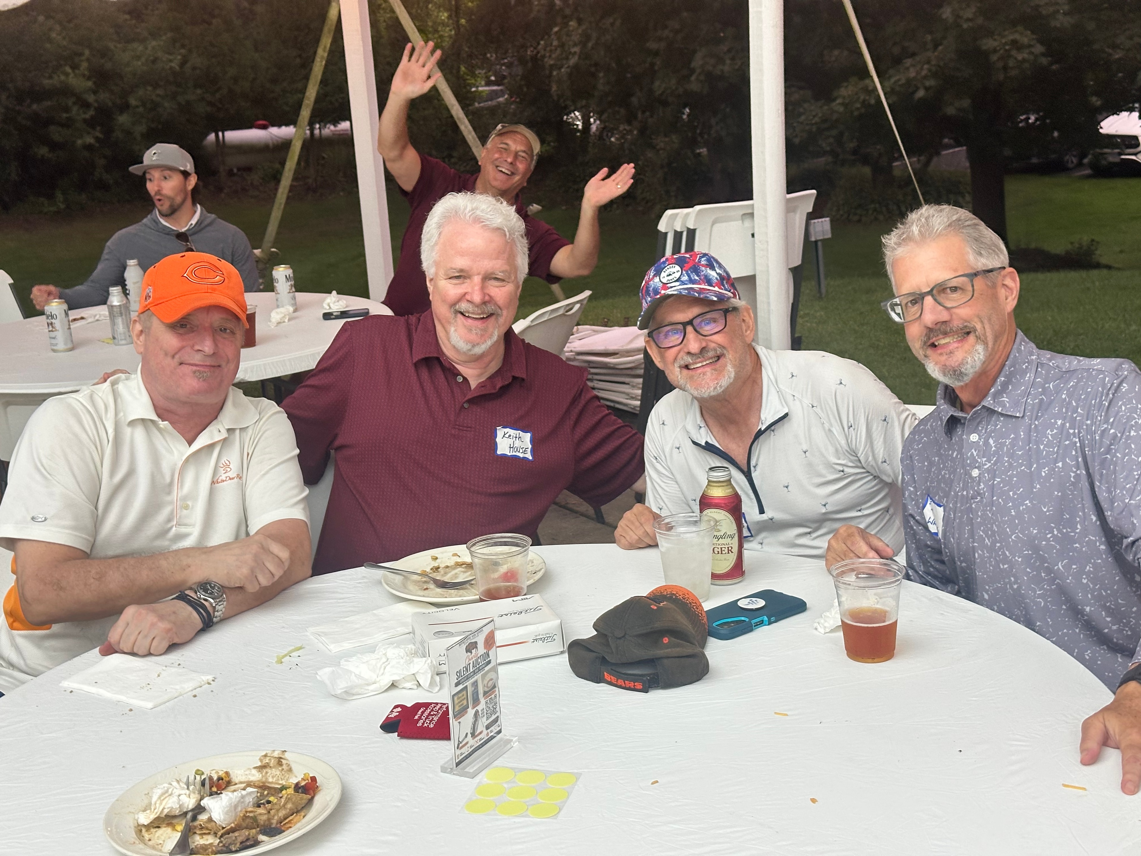 Group of men enjoying outdoor dinner gathering