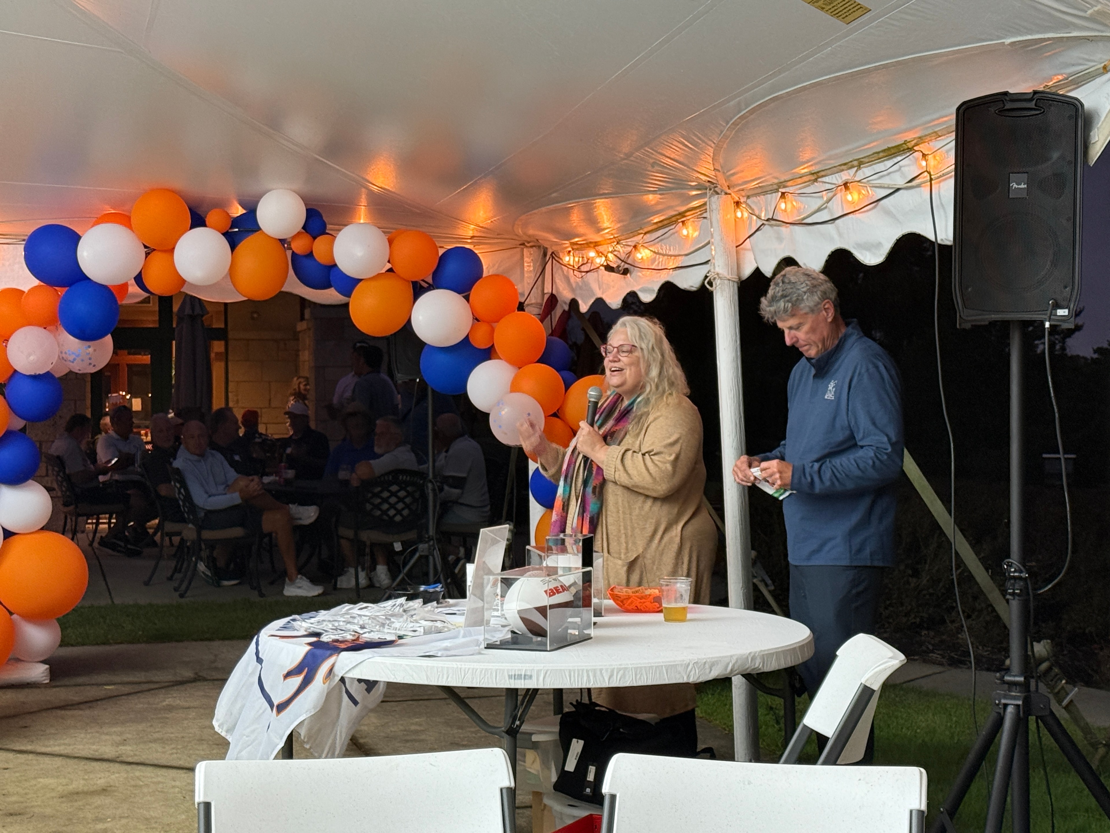 Outdoor event tent with colorful balloon decorations