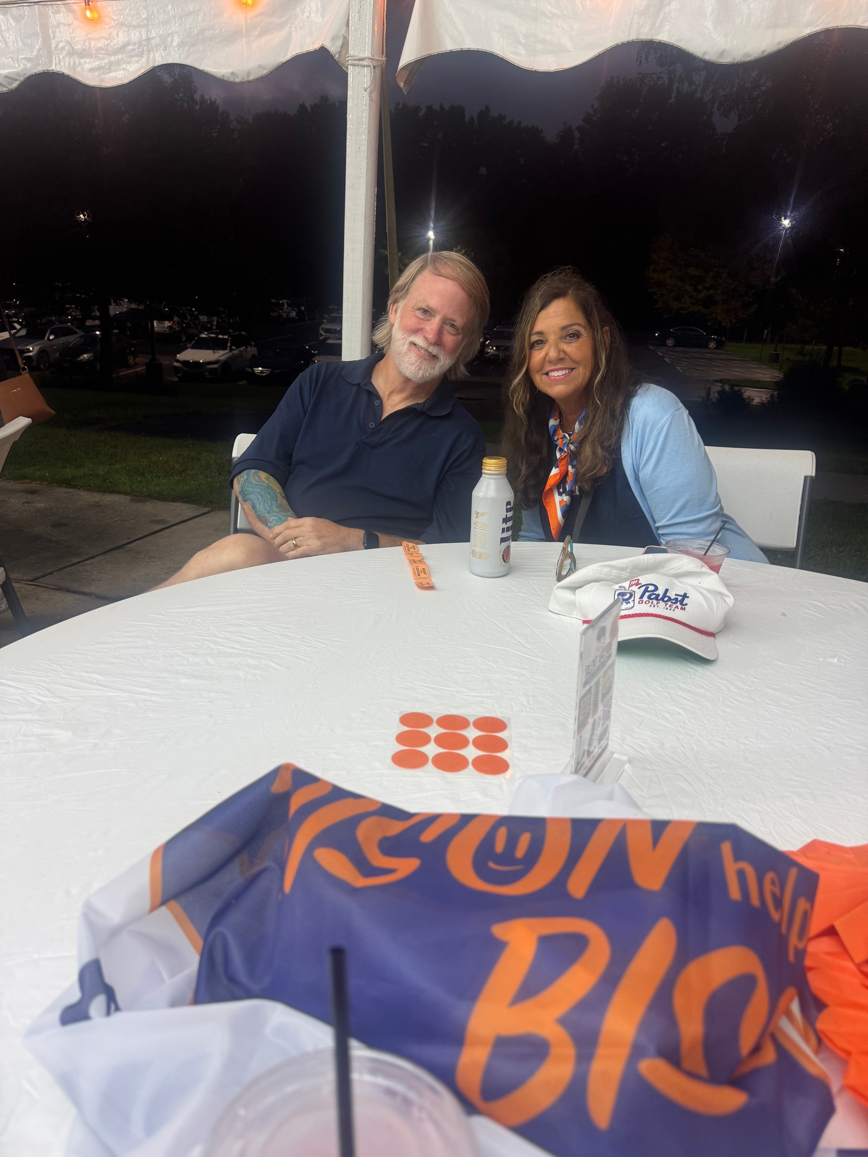 Couple at outdoor event table at night