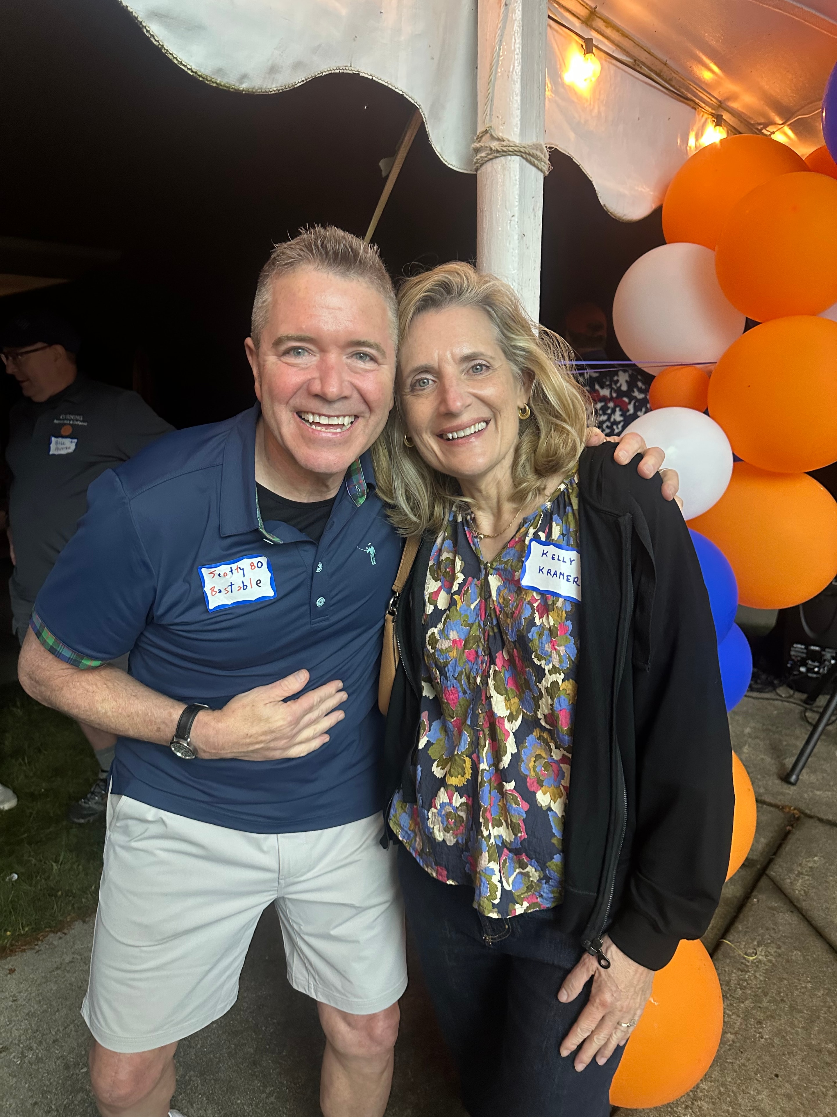 Two people smiling at outdoor event
