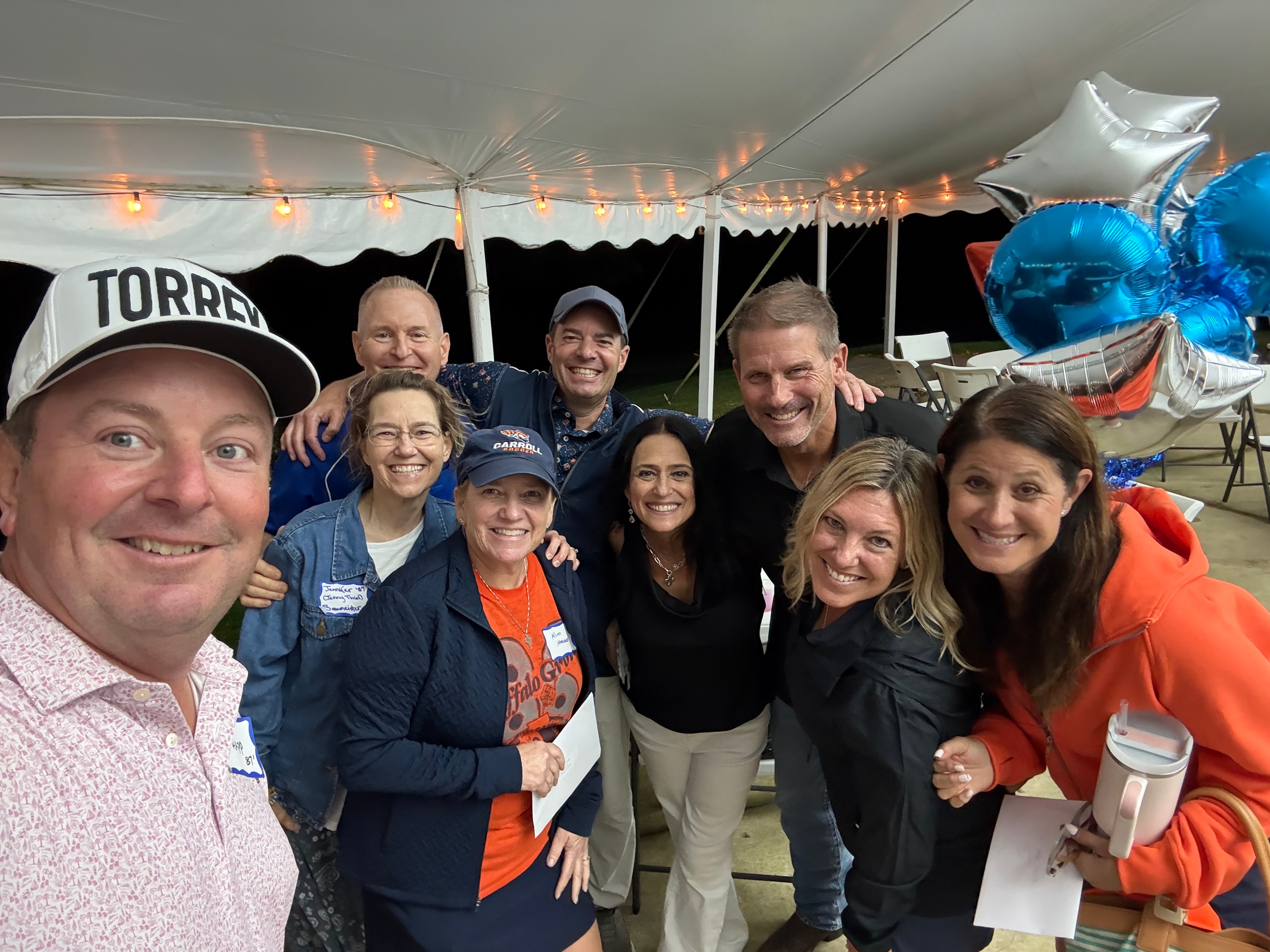 Group celebrating under tent at night