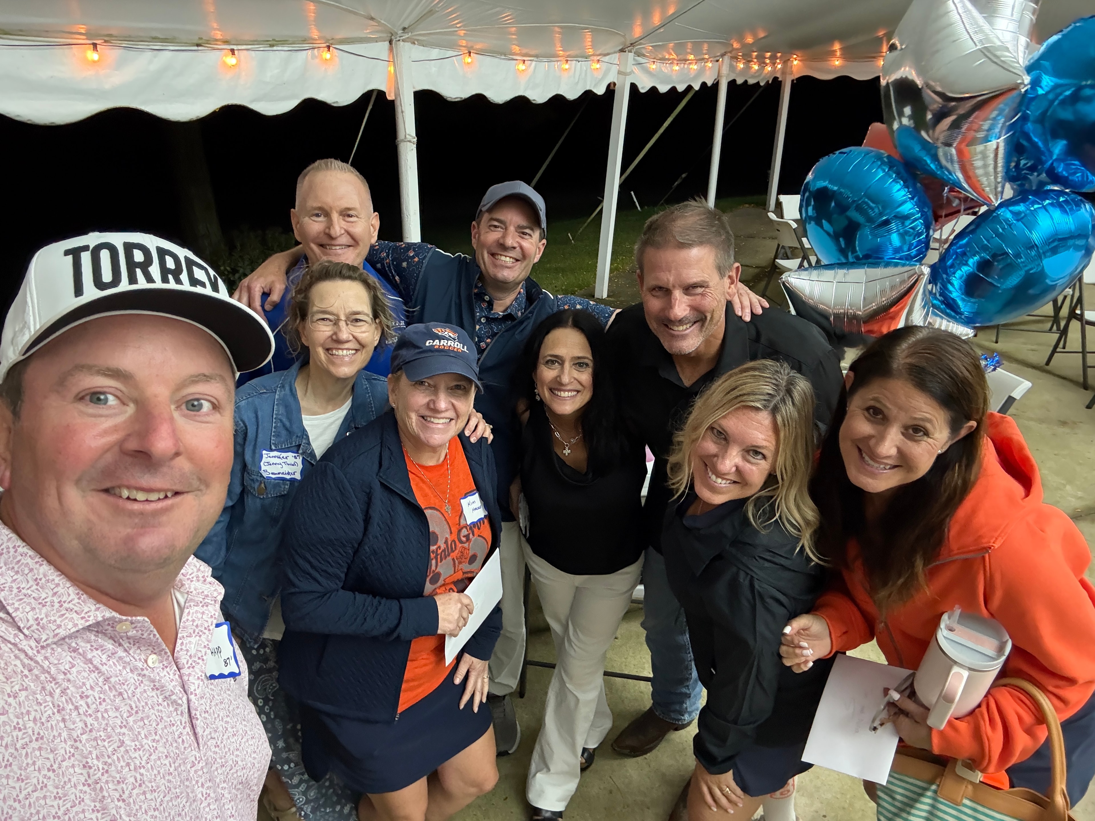 Group celebrating under tent at night