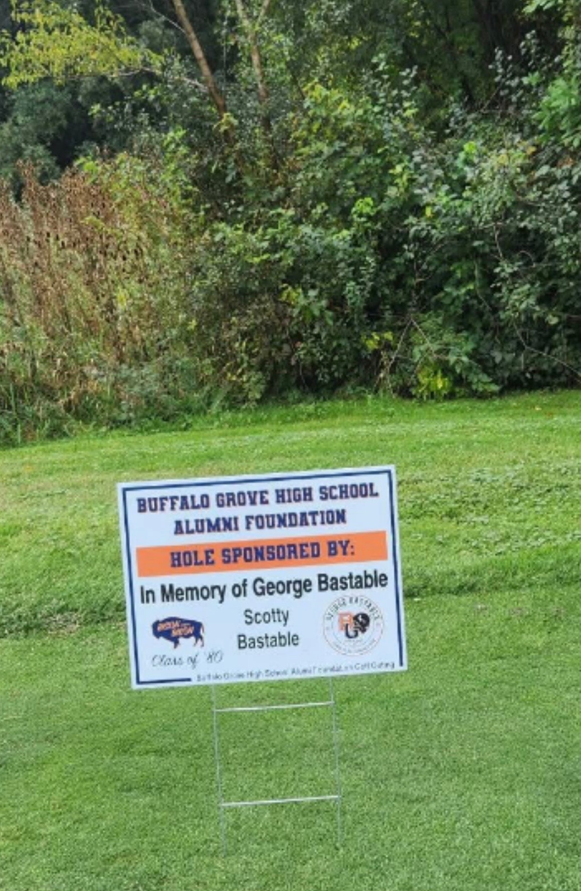 Memorial golf hole sponsor sign on lawn