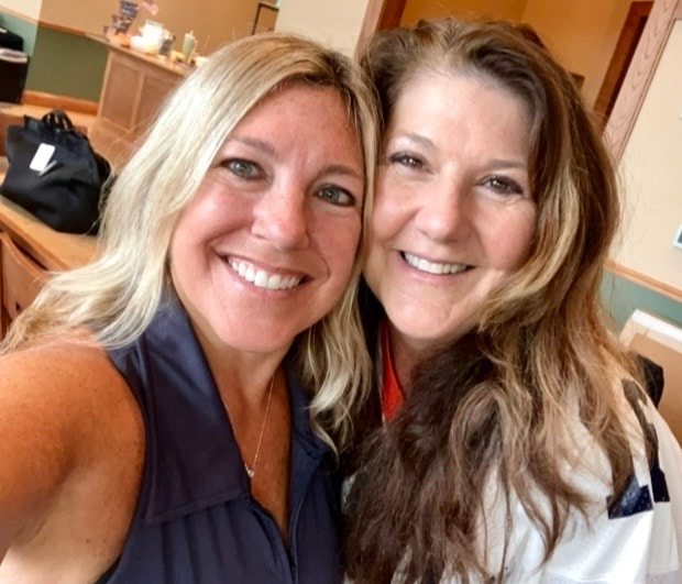 Two women smiling together indoors