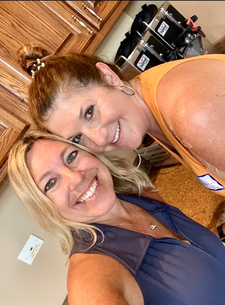 Two women smiling selfie indoors
