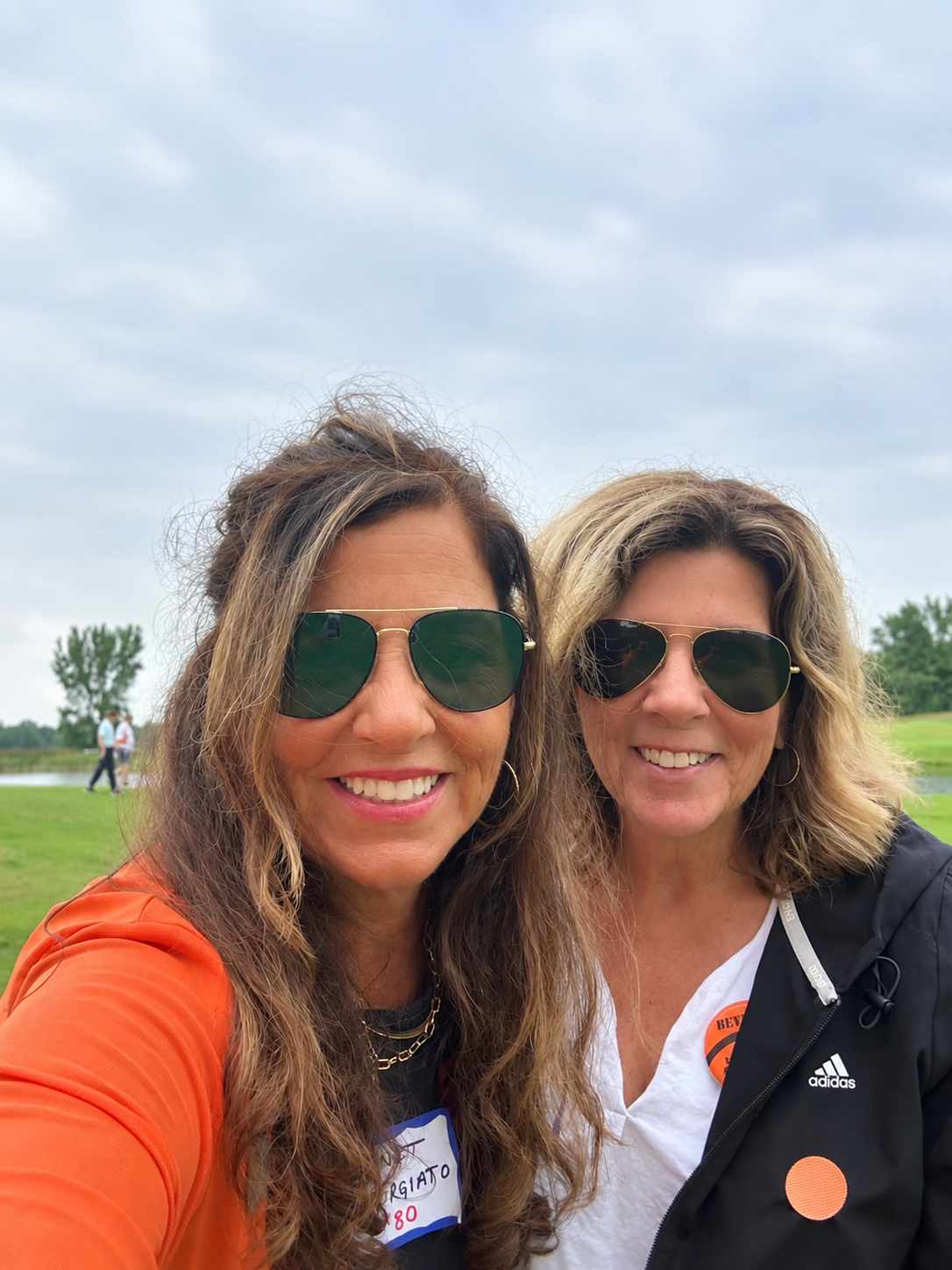 Two women wearing sunglasses outdoor portrait