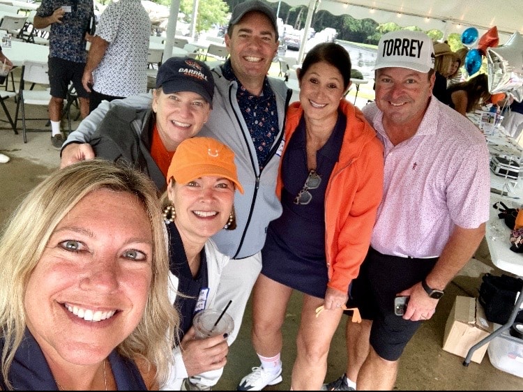 Group smiling at golf tournament event