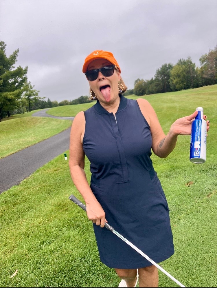 Woman golfing holding sunscreen playfully