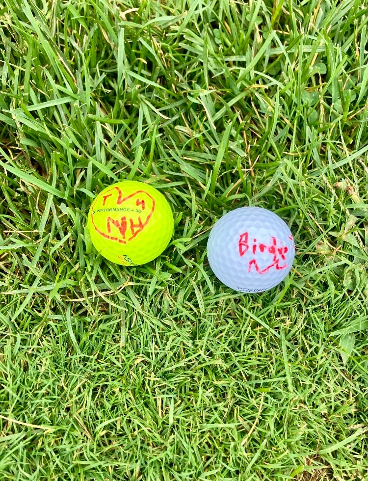 Two golf balls on grass