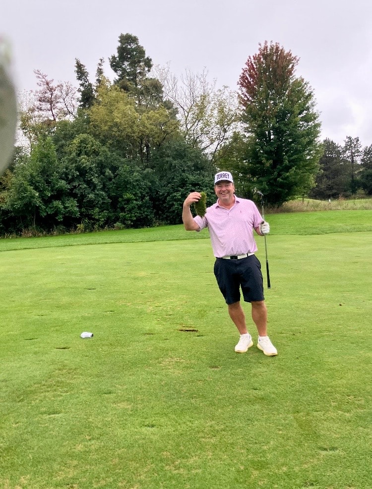 Man golfing on green fairway course